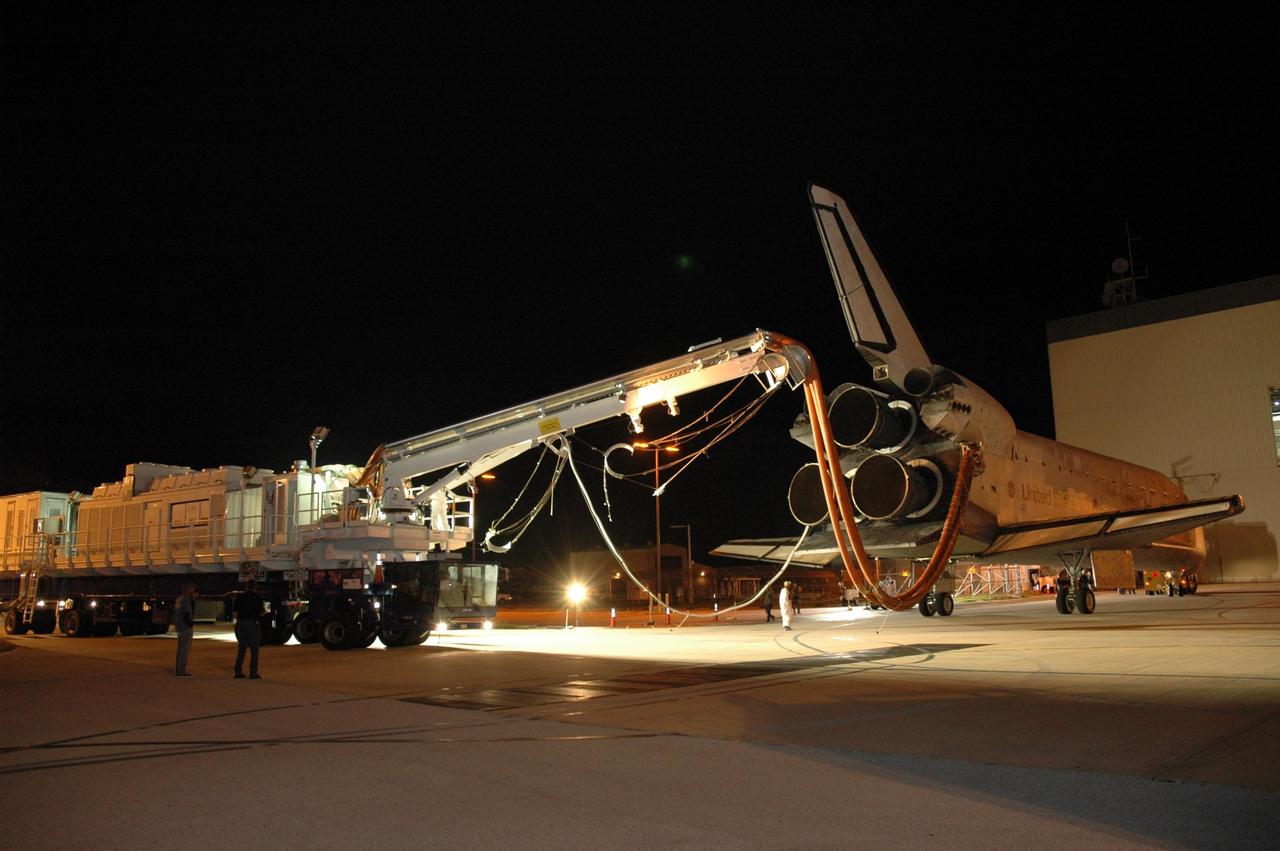 KENNEDY SPACE CENTER, FLA. --  The space shuttle Discovery nears the Orbital Processing Facility, or OPF, where processing Discovery for another flight begins.  Towing normally begins within four hours after landing and is completed within six hours unless removal of time-sensitive experiments is required on the runway.  Umbilicals are attached to purge the vehicle of any possible residual explosive or toxic fumes.  In the OPF, turnaround processing procedures on Discovery will include various post-flight deservicing and maintenance functions, which are carried out in parallel with payload removal and the installation of equipment needed for the next mission.  Before post-flight deservicing can continue beyond initial safing operations, certain vehicle systems must be mechanically secured and access platforms installed.  Discovery completed mission STS-120 with an on-time landing at 1:01 p.m. EST. Photo credit: NASA/Jim Grossmann