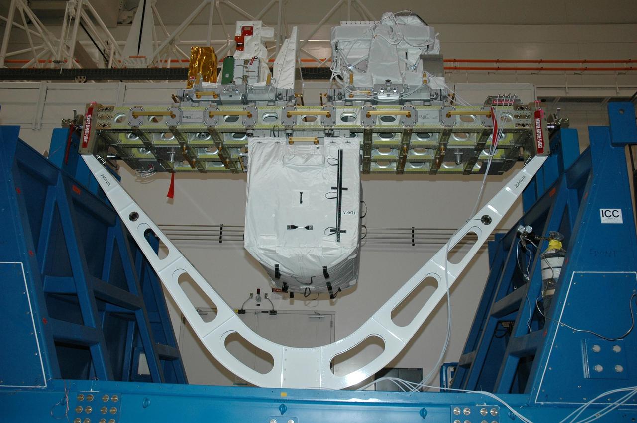 KENNEDY SPACE CENTER, FLA. -- In the Space Station Processing Facility at NASA's Kennedy Space Center, the integrated cargo carrier-lite, or ICC-L, is ready to be lifted and placed in the payload canister for mission STS-122. Joining the primary payload, the Columbus module, the ICC-L is an unpressurized cross-bay carrier providing launch and return transportation with the space shuttle. It rests on a keel yoke assembly, seen underneath. The ICC-L carries three elements: a nitrogen tank assembly that is part of the external active thermal control system on the International Space Station, the European technology Exposure Facility composed of nine science instruments and an autonomous temperature measurement unit, and the SOLAR payload designed for sun observation. The nitrogen tank assembly is mounted underneath. The exposure facility is seen at left on top, and the SOLAR is on the right. The SOLAR will be transferred and stowed on the Columbus module during the third spacewalk of the mission. STS-122 is targeted for launch on Dec. 6 on space shuttle Atlantis. Photo credit: NASA/Amanda Diller