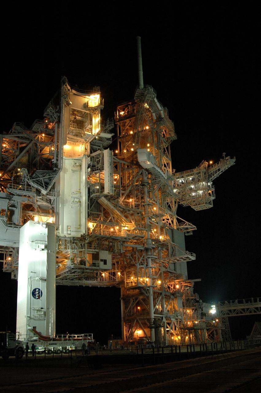 KENNEDY SPACE CENTER, FLA. -- At NASA's Kennedy Space Center, the payload canister atop its transporter reaches the top of Launch Pad 39A.  The canister will be positioned under the payload changeout room, on the rotating service structure at left.   The canister contains the Columbus Lab module and integrated cargo carrier-lite payloads for space shuttle Atlantis on mission STS-122.  They will be transferred into the payload changeout room on the pad. Atlantis is targeted to launch on Dec. 6.  Photo credit: NASA/Dimitri Gerondidakis