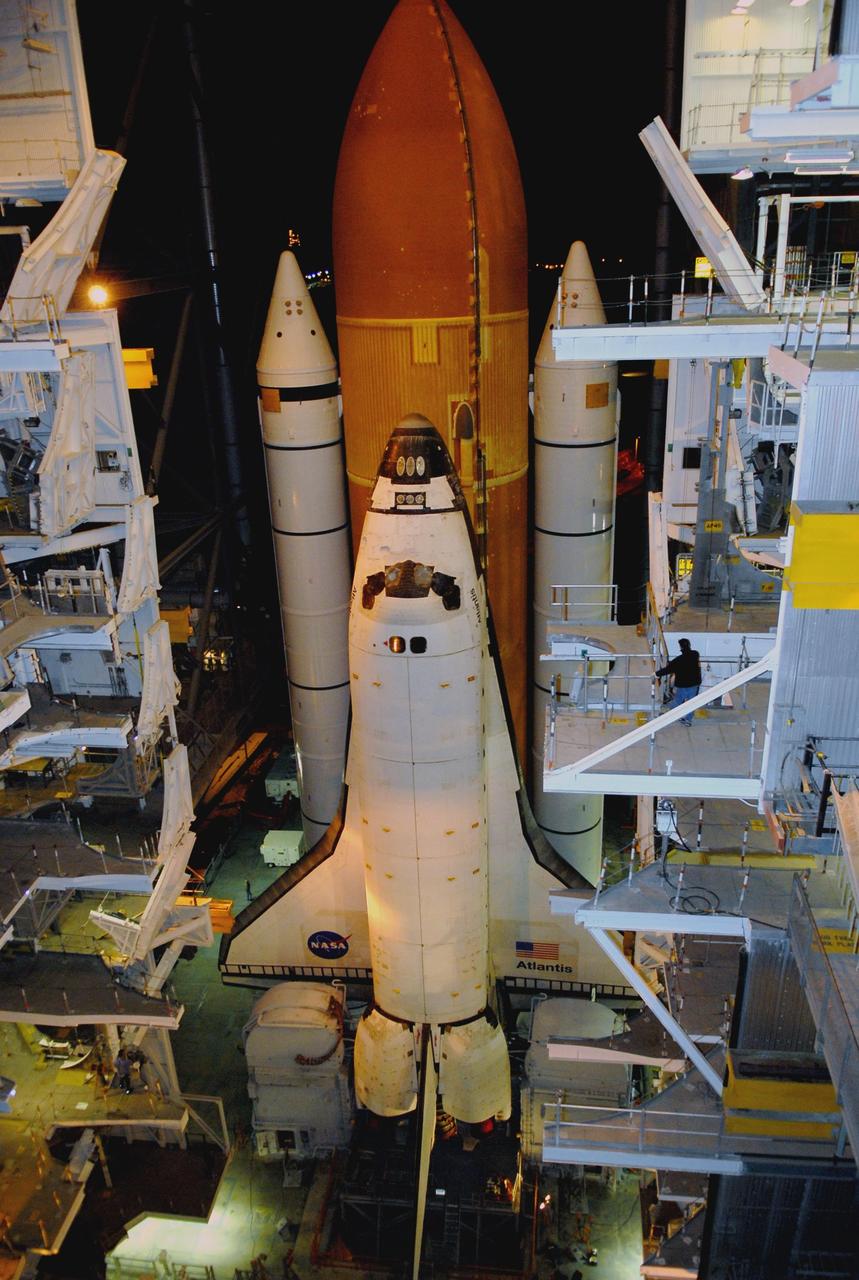 KENNEDY SPACE CENTER, FLA. -- Space Shuttle Atlantis begins moving through the doors of the Vehicle Assembly Building toward Launch Pad 39A before sunrise. First motion out of the VAB was at 4:43 a.m. EST. Rollout is a milestone for Atlantis' launch to the International Space Station on mission STS-122, targeted for Dec. 6. On this mission, Atlantis will deliver the Columbus module to the International Space Station. The European Space Agency's largest contribution to the station, Columbus is a multifunctional, pressurized laboratory that will be permanently attached to U.S. Node 2, called Harmony. The module is approximately 23 feet long and 15 feet wide, allowing it to hold 10 large racks of experiments. The laboratory will expand the research facilities aboard the station, providing crew members and scientists from around the world the ability to conduct a variety of experiments in the physical, materials and life sciences. Photo credit: NASA/Kim Shiflett