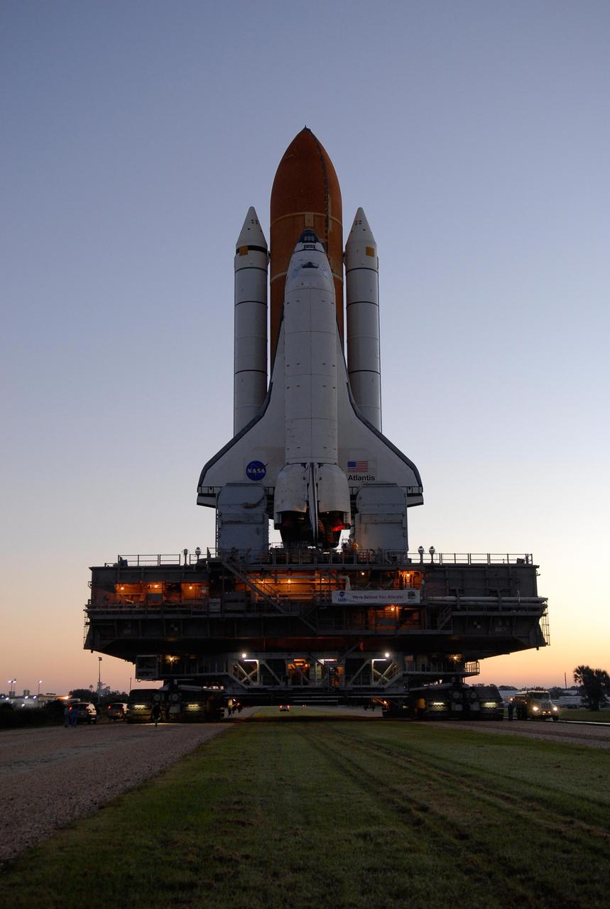 KENNEDY SPACE CENTER, FLA. -- A crawler transporter moves Space Shuttle Atlantis, secured atop a mobile launch platform, along the crawlerway from the Vehicle Assembly Building to Launch Pad 39A on a beautiful Florida morning. First motion out of the VAB was at 4:43 a.m. EST. The crawler transporter, mobile launch platform and unfueled space shuttle weigh a total of approximately 17.5 million pounds. Rollout is a milestone for Atlantis' launch to the International Space Station on mission STS-122, targeted for Dec. 6. On this mission, Atlantis will deliver the Columbus module to the International Space Station. The European Space Agency's largest contribution to the station, Columbus is a multifunctional, pressurized laboratory that will be permanently attached to U.S. Node 2, called Harmony. The module is approximately 23 feet long and 15 feet wide, allowing it to hold 10 large racks of experiments. The laboratory will expand the research facilities aboard the station, providing crew members and scientists from around the world the ability to conduct a variety of experiments in the physical, materials and life sciences. Photo credit: NASA/Kim Shiflett