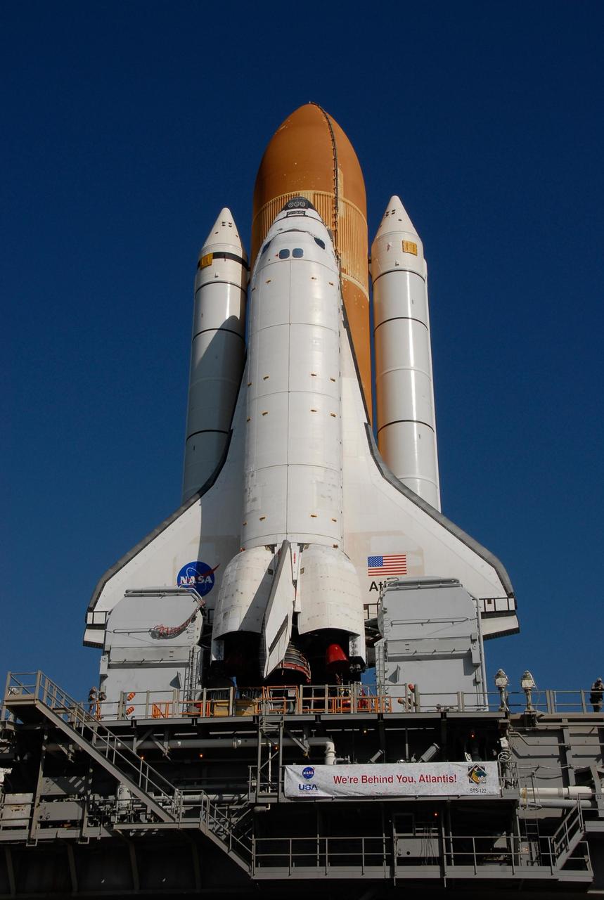 KENNEDY SPACE CENTER, FLA. -- A banner affixed to the mobile launch platform proclaims the sentiments of the work force at Kennedy Space Center as Space Shuttle Atlantis makes its way to Launch Pad 39A. First motion out of the Vehicle Assembly Building was at 4:43 a.m. EST. Rollout is a milestone for Atlantis' launch to the International Space Station on mission STS-122, targeted for Dec. 6. On this mission, Atlantis will deliver the Columbus module to the International Space Station. The European Space Agency's largest contribution to the station, Columbus is a multifunctional, pressurized laboratory that will be permanently attached to U.S. Node 2, called Harmony. The module is approximately 23 feet long and 15 feet wide, allowing it to hold 10 large racks of experiments. The laboratory will expand the research facilities aboard the station, providing crew members and scientists from around the world the ability to conduct a variety of experiments in the physical, materials and life sciences. Photo credit: NASA/Kim Shiflett