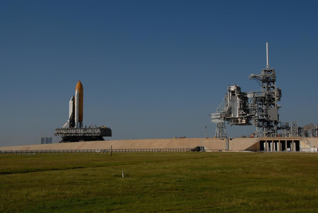 KENNEDY SPACE CENTER, FLA. -- Space Shuttle Atlantis, secured atop a mobile launch platform, ascends the five percent grade to the top of the hardstand on Launch Pad 39A. The rotating service structure, adjoined to the fixed service structure at right, has been rolled back in preparation for the shuttle's arrival. First motion out of the Vehicle Assembly Building was at 4:43 a.m. EST, and the shuttle was hard down on the pad at 11:51 a.m. Rollout is a milestone for Atlantis' launch to the International Space Station on mission STS-122, targeted for Dec. 6. On this mission, Atlantis will deliver the Columbus module to the International Space Station. The European Space Agency's largest contribution to the station, Columbus is a multifunctional, pressurized laboratory that will be permanently attached to U.S. Node 2, called Harmony. The module is approximately 23 feet long and 15 feet wide, allowing it to hold 10 large racks of experiments. The laboratory will expand the research facilities aboard the station, providing crew members and scientists from around the world the ability to conduct a variety of experiments in the physical, materials and life sciences. Photo credit: NASA/Kim Shiflett