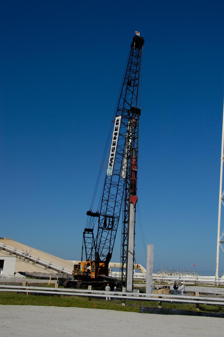 KENNEDY SPACE CENTER, FLA. --  On Launch Pad 39B at NASA's Kennedy Space Center,  the crane crawler continues pounding a piling into the ground to help construct lightning towers for the Constellation Program and Ares/Orion launches.  Pad B will be the site of the first Ares vehicle launch, including Ares I-X which is scheduled for April 2009.  Photo credit: NASA/George Shelton