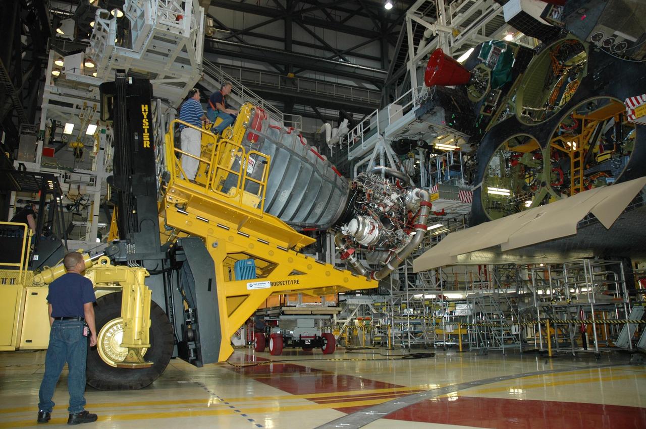 KENNEDY SPACE CENTER, FLA. --  In Orbiter Processing Facility bay 3 at NASA's Kennedy Space Center, technicians on a Hyster forklift move space shuttle main engine no. 1 toward Endeavour for installation.  Each space shuttle main engine is 14 feet long, weighs about 6,700 pounds, and is 7.5 feet in diameter at the end of the nozzle. The orbiter is targeted for launch on Feb. 14 for mission STS-123 to the International Space Station.  Photo credit: NASA/Jack Pfaller