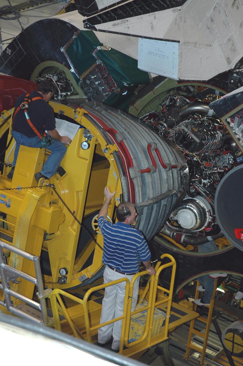 KENNEDY SPACE CENTER, FLA. --  In Orbiter Processing Facility bay 3 at NASA's Kennedy Space Center, technicians on a Hyster forklift maneuver space shuttle main engine no. 1 into place on Endeavour. Each space shuttle main engine is 14 feet long, weighs about 6,700 pounds, and is 7.5 feet in diameter at the end of the nozzle. The orbiter is targeted for launch on Feb. 14 for mission STS-123 to the International Space Station.  Photo credit: NASA/Jack Pfaller