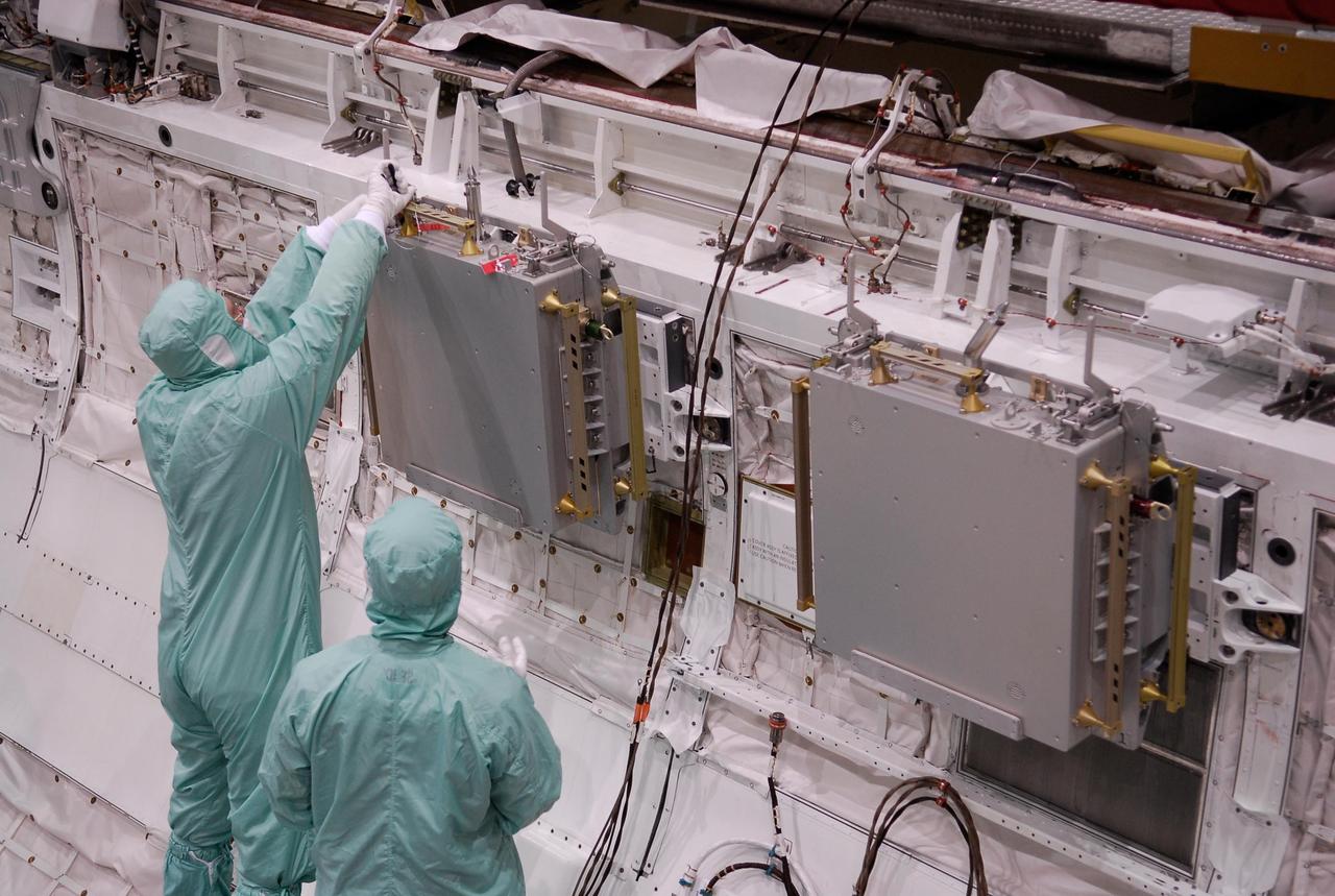 KENNEDY SPACE CENTER, FLA. -- In the Orbiter Processing Facility, technicians install the second Materials International Space Station Experiments, or MISSE, in space shuttle Endeavour's payload bay. The MISSE is part of the payload onboard Endeavour for mission STS-123. The MISSE project is a NASA/Langley Research Center-managed cooperative endeavor to fly materials and other types of space exposure experiments on the International Space Station. The objective is to develop early, low-cost, non-intrusive opportunities to conduct critical space exposure tests of space materials and components planned for use on future spacecraft. Photo credit: NASA/Kim Shiflett