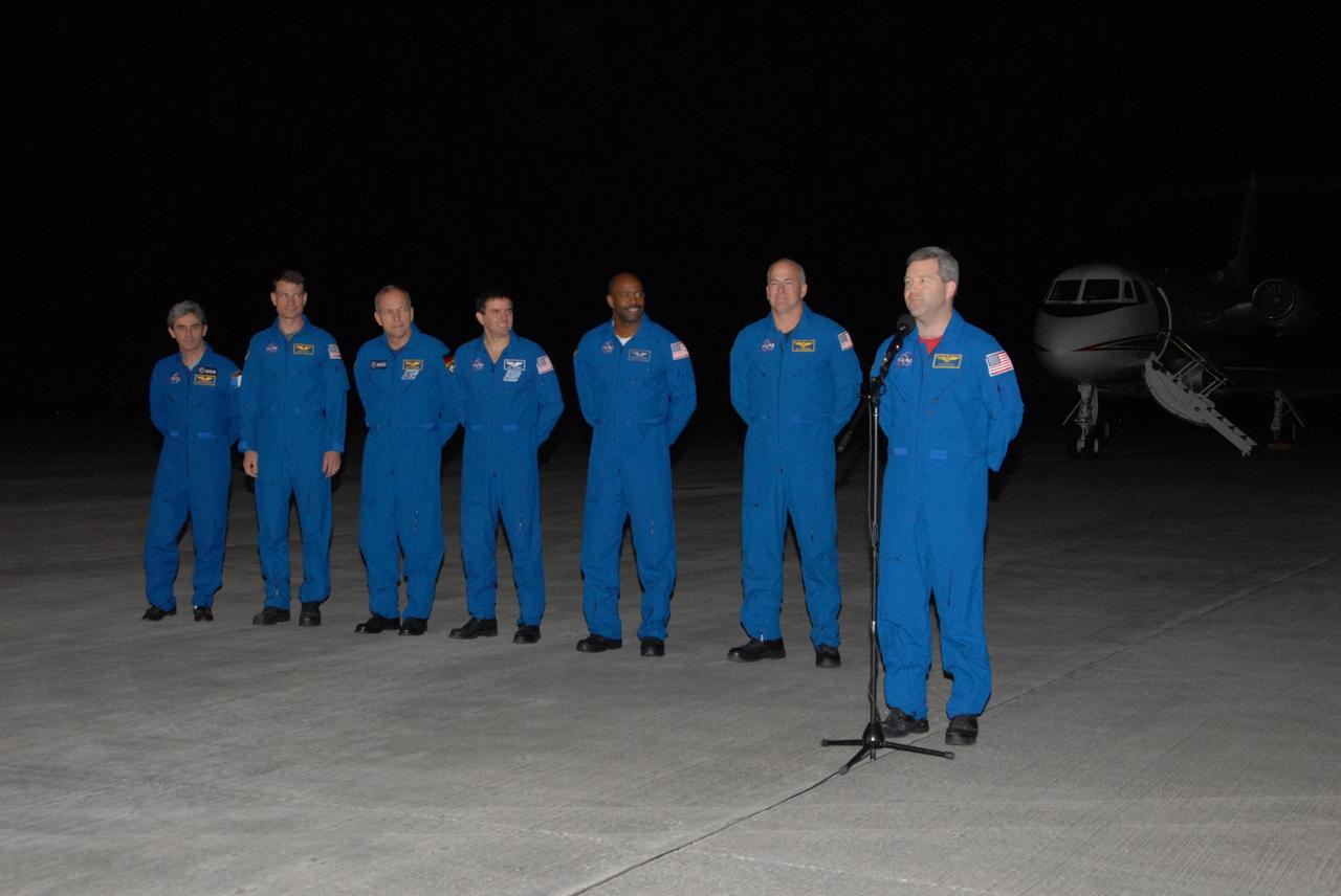 KENNEDY SPACE CENTER, FLA. --  Space shuttle Atlantis STS-122 Commander Steve Frick, at the microphone, addresses the media at Kennedy Space Center's Shuttle Landing Facility following his arrival to participate in three days of terminal countdown demonstration test, or TCDT, activities. Other STS-122 crew members are, from left, Mission Specialist Leopold Eyharts, a European Space Agency astronaut who will remain on the International Space Station as a flight engineer for Expedition 16; Mission Specialists Stanley Love, Hans Schlegel of the European Space Agency, Rex Walheim and Leland Melvin; and Pilot Alan Poindexter. The TCDT provides astronauts and ground crews with equipment familiarization, emergency egress training and a simulated launch countdown. On mission STS-122, Atlantis will deliver the Columbus module to the International Space Station. The European Space Agency's largest single contribution to the station, Columbus is a multifunctional, pressurized laboratory that will be permanently attached to U.S. Node 2, called Harmony. The laboratory will expand the research facilities aboard the station, providing crew members and scientists from around the world the ability to conduct a variety of experiments in the physical, materials and life sciences. Photo credit: NASA/George Shelton