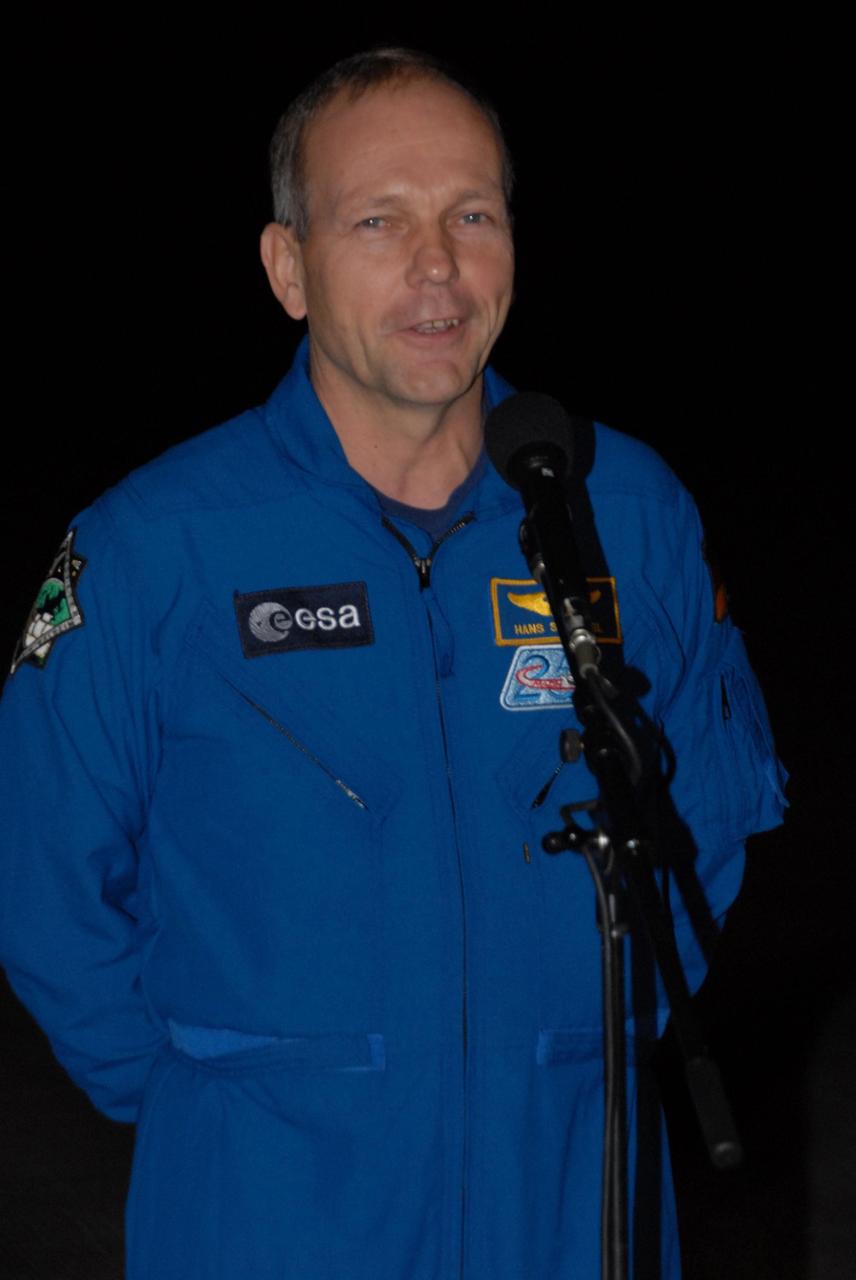 KENNEDY SPACE CENTER, FLA. --  Space shuttle Atlantis STS-122 Mission Specialist Hans Schlegel, of the European Space Agency, talks to the media at Kennedy Space Center's Shuttle Landing Facility following his arrival to participate in three days of terminal countdown demonstration test, or TCDT, activities.  The TCDT provides astronauts and ground crews with equipment familiarization, emergency egress training and a simulated launch countdown. On mission STS-122, Atlantis will deliver the Columbus module to the International Space Station. The European Space Agency's largest single contribution to the station, Columbus is a multifunctional, pressurized laboratory that will be permanently attached to U.S. Node 2, called Harmony. The laboratory will expand the research facilities aboard the station, providing crew members and scientists from around the world the ability to conduct a variety of experiments in the physical, materials and life sciences. Photo credit: NASA/George Shelton