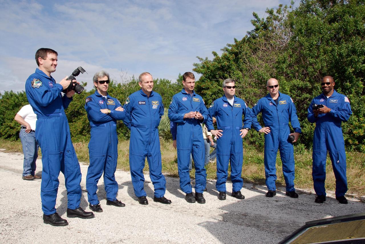 KENNEDY SPACE CENTER, FLA. --  The STS-122 crew poses for a group portrait near Launch Pad 39B during a training session on the operation of the M-113 armored personnel carrier.  An M-113 will be available to transport the crew to safety in the event of an emergency on the pad before their launch.  From left are Mission Specialists Rex Walheim, Leopold Eyharts and Hans Schlegel of the European Space Agency, Stanley Love; Commander Steve Frick; Pilot Alan Poindexter; and Mission Specialist Leland Melvin.  The crew is participating in Terminal Countdown Demonstration Test activities, a standard part of launch preparations. The TCDT provides astronauts and ground crews with equipment familiarization, emergency egress training and a simulated launch countdown. On mission STS-122, Atlantis will deliver the European Space Agency's Columbus module to the International Space Station.  Columbus is a multifunctional, pressurized laboratory that will be permanently attached to U.S. Node 2, called Harmony, and will expand the research facilities aboard the station. Launch is targeted for Dec. 6.  Photo credit: NASA/Kim Shiflett