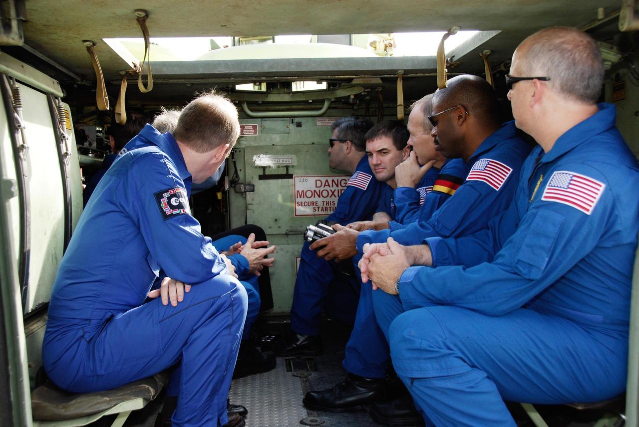 KENNEDY SPACE CENTER, FLA. -- Members of the STS-122 crew receive a briefing inside an M-113 armored personnel carrier near Launch Pad 39B. An M-113 will be available to transport the crew to safety in the event of an emergency on the pad before their launch. Seated on the bench at left is European Space Agency astronaut Frank De Winne, the backup for STS-122 Mission Specialist Leopold Eyharts. Seated on the bench at right, from back to front are Commander Steve Frick; Mission Specialists Rex Walheim, Hans Schlegel of the European Space Agency, and Leland Melvin; and Pilot Alan Poindexter. The crew is participating in Terminal Countdown Demonstration Test activities, a standard part of launch preparations. The TCDT provides astronauts and ground crews with equipment familiarization, emergency egress training and a simulated launch countdown. On mission STS-122, Atlantis will deliver the European Space Agency's Columbus module to the International Space Station. Columbus is a multifunctional, pressurized laboratory that will be permanently attached to U.S. Node 2, called Harmony, and will expand the research facilities aboard the station. Launch is targeted for Dec. 6. Photo credit: NASA/Kim Shiflett