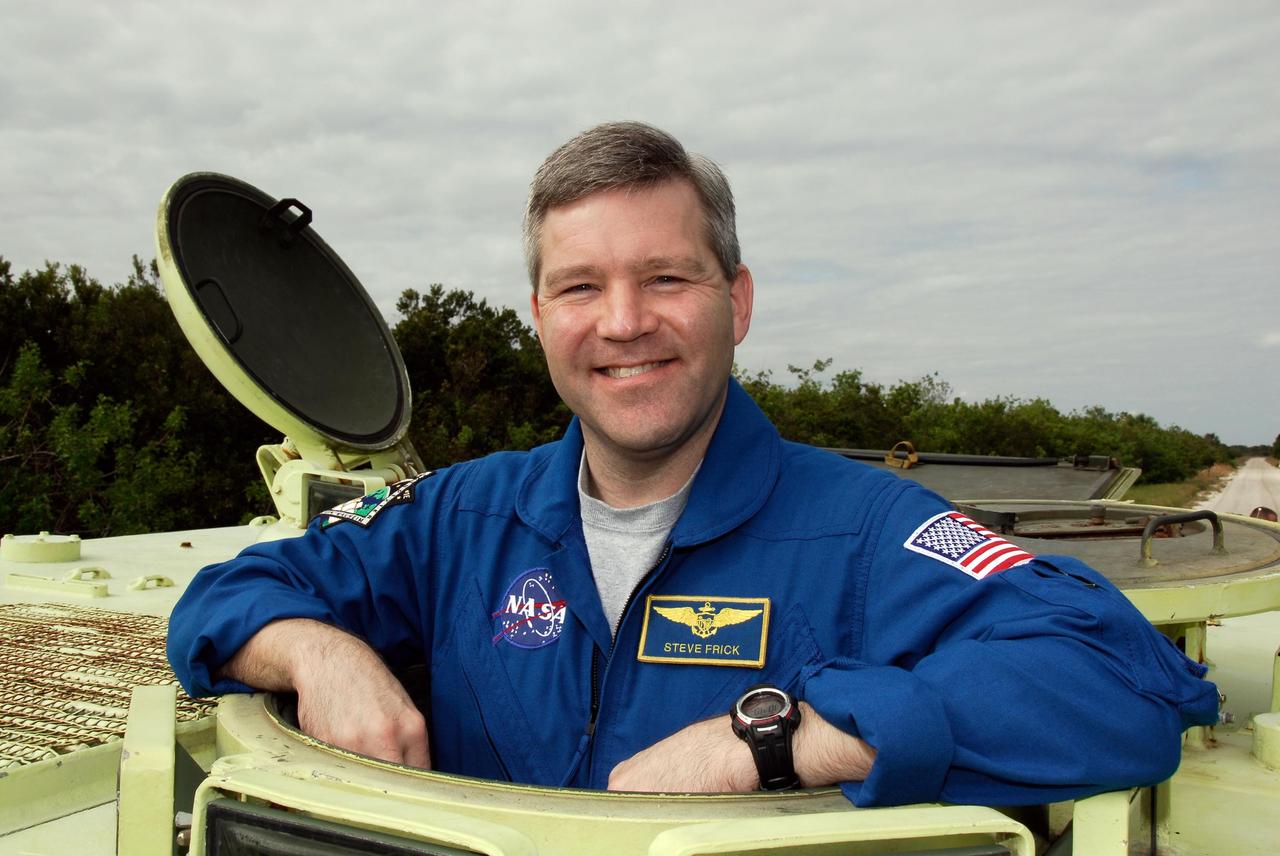 KENNEDY SPACE CENTER, FLA. --  STS-122 Commander Stephen Frick takes time out from driving practice of the M-113 armored personnel carrier to pose for a photo.  The practice near Launch Pad 39B is part of training on emergency egress procedures. An M-113 will be available to transport the crew to safety in the event of a contingency on the pad before their launch. The crew is participating in Terminal Countdown Demonstration Test activities, a standard part of launch preparations. The TCDT provides astronauts and ground crews with equipment familiarization, emergency egress training and a simulated launch countdown. On mission STS-122, Atlantis will deliver the European Space Agency's Columbus module to the International Space Station.  Columbus is a multifunctional, pressurized laboratory that will be permanently attached to U.S. Node 2, called Harmony, and will expand the research facilities aboard the station. Launch is targeted for Dec. 6.  Photo credit: NASA/Kim Shiflett