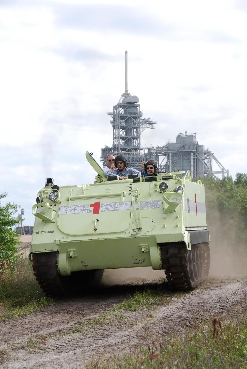 KENNEDY SPACE CENTER, FLA. --  STS-122 Mission Specialist Rex Walheim, at right, practices driving an M-113 armored personnel carrier as the instructor beside him monitors his performance.  The practice near Launch Pad 39B is part of training on emergency egress procedures. An M-113 will be available to transport the crew to safety in the event of a contingency on the pad before their launch.  The crew is participating in Terminal Countdown Demonstration Test activities, a standard part of launch preparations. The TCDT provides astronauts and ground crews with equipment familiarization, emergency egress training and a simulated launch countdown. On mission STS-122, Atlantis will deliver the European Space Agency's Columbus module to the International Space Station.  Columbus is a multifunctional, pressurized laboratory that will be permanently attached to U.S. Node 2, called Harmony, and will expand the research facilities aboard the station. Launch is targeted for Dec. 6.  Photo credit: NASA/Kim Shiflett