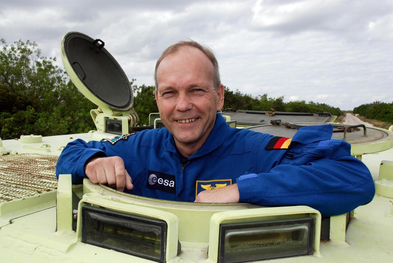 KENNEDY SPACE CENTER, FLA. --  STS-122 Mission Specialist Hans Schlegel, of the European Space Agency, takes time out from driving practice of the M-113 armored personnel carrier to pose for a photo.  The practice near Launch Pad 39B is part of training on emergency egress procedures. An M-113 will be available to transport the crew to safety in the event of a contingency on the pad before their launch.  The crew is participating in Terminal Countdown Demonstration Test activities, a standard part of launch preparations. The TCDT provides astronauts and ground crews with equipment familiarization, emergency egress training and a simulated launch countdown. On mission STS-122, Atlantis will deliver the European Space Agency's Columbus module to the International Space Station.  Columbus is a multifunctional, pressurized laboratory that will be permanently attached to U.S. Node 2, called Harmony, and will expand the research facilities aboard the station. Launch is targeted for Dec. 6.  Photo credit: NASA/Kim Shiflett