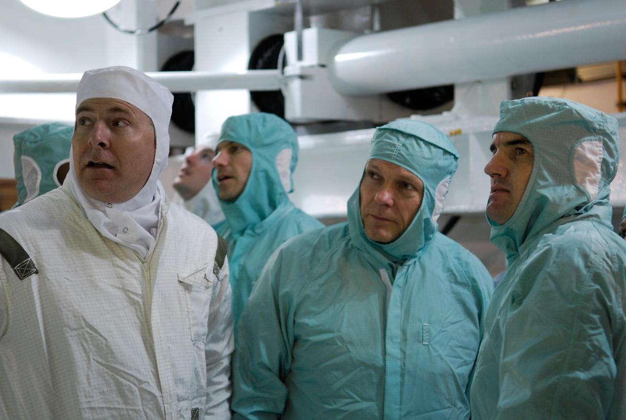 KENNEDY SPACE CENTER, FLA. --  At Launch Pad 39A, members of the space shuttle Atlantis STS-122 crew view the Columbus module during terminal countdown demonstration test, or TCDT, activities.  Columbus was installed in the orbiter's payload bay on Nov. 11.  From left, in clean room attire, are Pilot Alan Poindexter and Mission Specialists Stanley Love, Hans Schlegel of the European Space Agency and Rex Walheim. The TCDT provides astronauts and ground crews with equipment familiarization, emergency egress training and a simulated launch countdown. On mission STS-122, Atlantis will deliver the Columbus module to the International Space Station. The European Space Agency's largest single contribution to the station, Columbus is a multifunctional, pressurized laboratory that will be permanently attached to U.S. Node 2, called Harmony. The module is approximately 23 feet long and 15 feet wide, allowing it to hold 10 large racks of experiments. The laboratory will expand the research facilities aboard the station, providing crew members and scientists from around the world the ability to conduct a variety of experiments in the physical, materials and life sciences.  Launch is targeted for Dec. 6.  Photo credit: NASA/Kim Shiflett