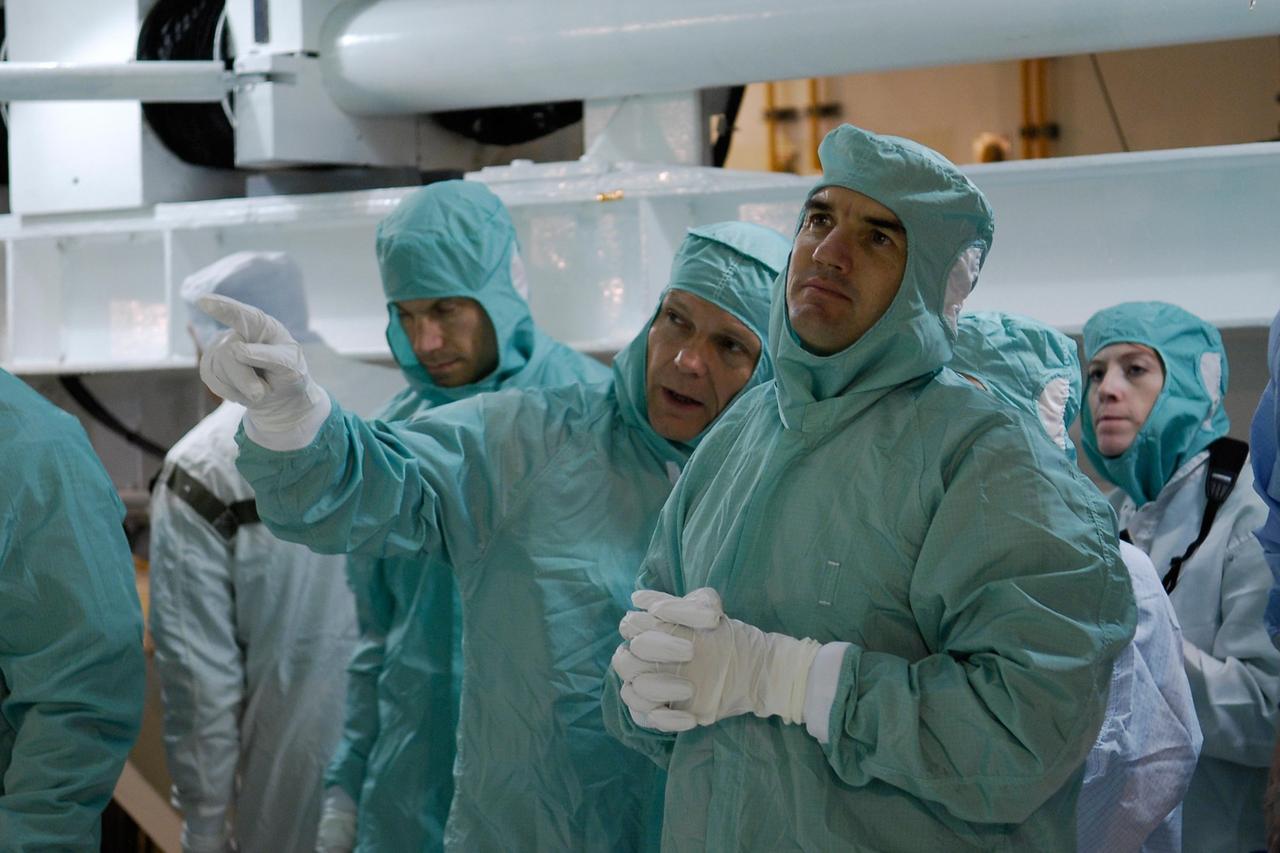 KENNEDY SPACE CENTER, FLA. -- At Launch Pad 39A, members of the space shuttle Atlantis STS-122 crew get a close look at the Columbus module during terminal countdown demonstration test, or TCDT, activities. Columbus was installed in the orbiter's payload bay on Nov. 11. From left, in clean room attire, are Mission Specialists Stanley Love, Hans Schlegel of the European Space Agency and Rex Walheim. The TCDT provides astronauts and ground crews with equipment familiarization, emergency egress training and a simulated launch countdown. On mission STS-122, Atlantis will deliver the Columbus module to the International Space Station. The European Space Agency's largest single contribution to the station, Columbus is a multifunctional, pressurized laboratory that will be permanently attached to U.S. Node 2, called Harmony. The module is approximately 23 feet long and 15 feet wide, allowing it to hold 10 large racks of experiments. The laboratory will expand the research facilities aboard the station, providing crew members and scientists from around the world the ability to conduct a variety of experiments in the physical, materials and life sciences. Launch is targeted for Dec. 6. Photo credit: NASA/Kim Shiflett