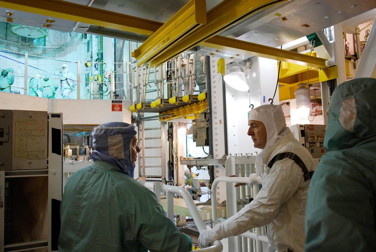 KENNEDY SPACE CENTER, FLA. --  At Launch Pad 39A, members of the space shuttle Atlantis STS-122 crew view the Columbus module during terminal countdown demonstration test, or TCDT, activities.  Columbus was installed in the orbiter's payload bay on Nov. 11.  From left, in clean room attire, are former astronaut Jerry Ross, chief of the Vehicle Integration Test Office at NASA Johnson Space Center, Pilot Alan Poindexter and Commander Steve Frick.   The TCDT provides astronauts and ground crews with equipment familiarization, emergency egress training and a simulated launch countdown. On mission STS-122, Atlantis will deliver the Columbus module to the International Space Station. The European Space Agency's largest single contribution to the station, Columbus is a multifunctional, pressurized laboratory that will be permanently attached to U.S. Node 2, called Harmony. The module is approximately 23 feet long and 15 feet wide, allowing it to hold 10 large racks of experiments. The laboratory will expand the research facilities aboard the station, providing crew members and scientists from around the world the ability to conduct a variety of experiments in the physical, materials and life sciences.  Launch is targeted for Dec. 6.  Photo credit: NASA/Kim Shiflett