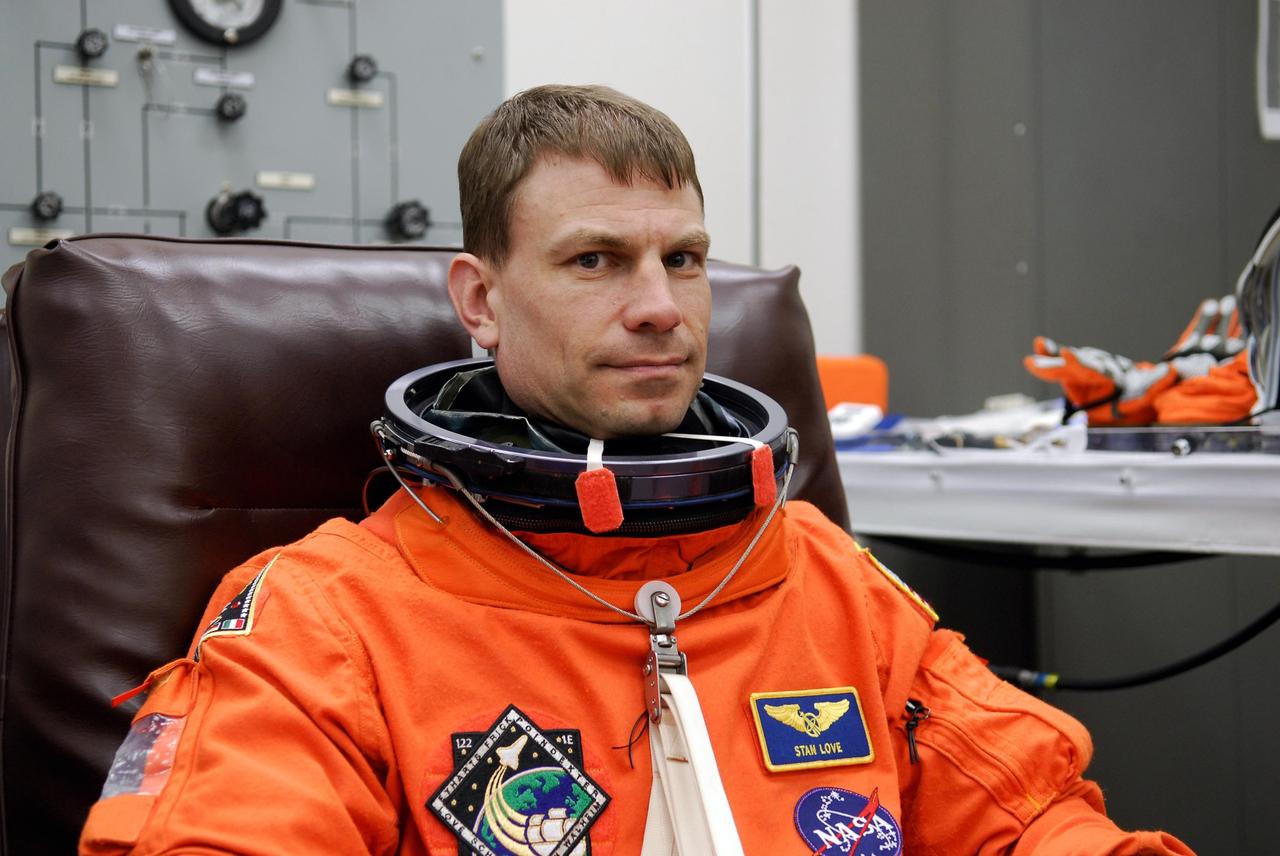 KENNEDY SPACE CENTER, FLA. --  Space shuttle Atlantis STS-122 Mission Specialist Stanley Love tries on his launch and entry suit, preparing for launch. The fitting is part of terminal countdown demonstration test, or TCDT, activities the crew is undertaking at NASA's Kennedy Space Center.  The TCDT provides astronauts and ground crews with equipment familiarization, emergency egress training and a simulated launch countdown. On mission STS-122, Atlantis will deliver the Columbus module to the International Space Station. The European Space Agency's largest single contribution to the station, Columbus is a multifunctional, pressurized laboratory that will be permanently attached to U.S. Node 2, called Harmony. The laboratory will expand the research facilities aboard the station, providing crew members and scientists from around the world the ability to conduct a variety of experiments in the physical, materials and life sciences. Launch is targeted for Dec. 6.  Photo credit: NASA/Kim Shiflett