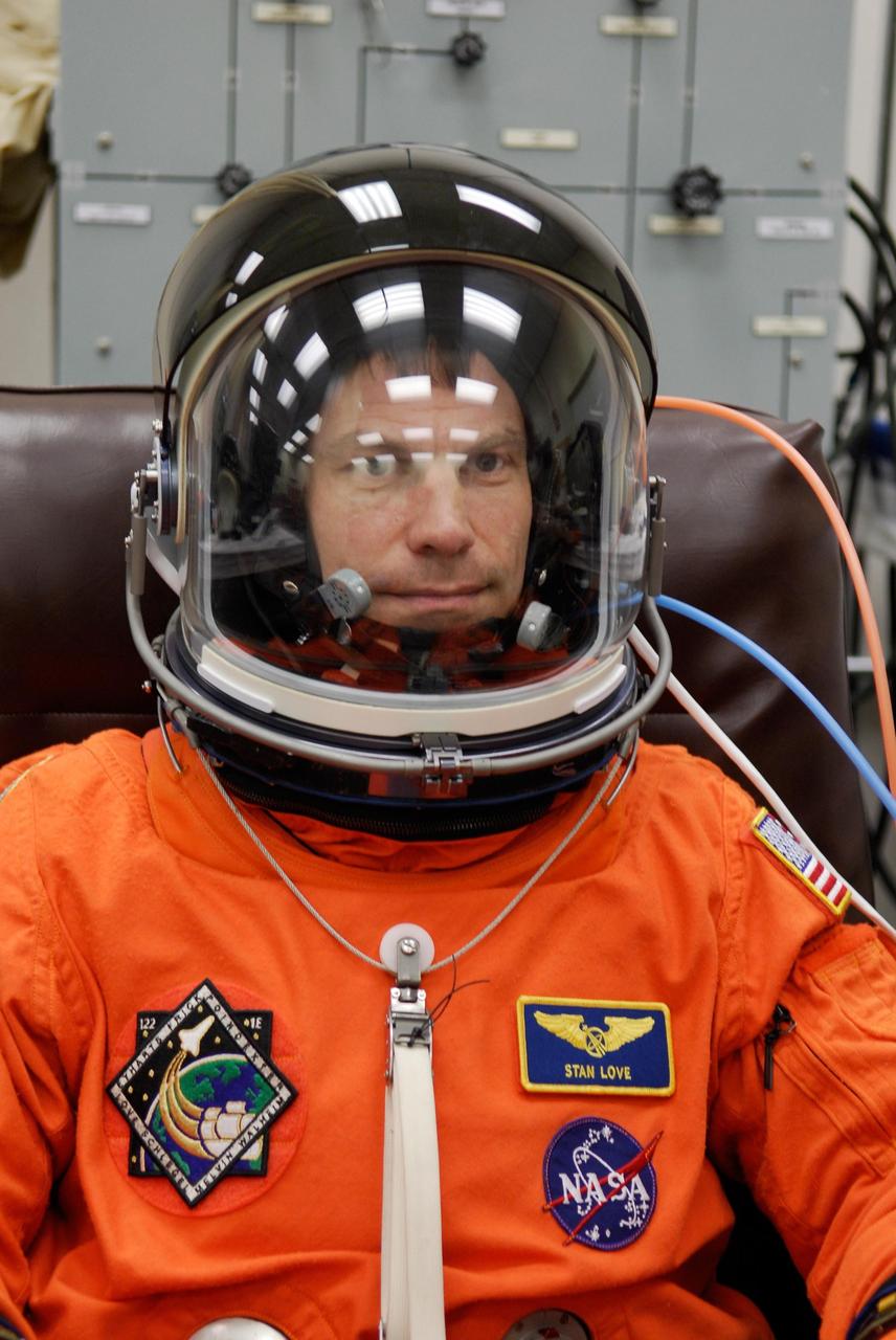 KENNEDY SPACE CENTER, FLA. --  Space shuttle Atlantis STS-122 Mission Specialist Stanley Love has his helmet fitted on his launch and entry suit, preparing for launch. The fitting is part of terminal countdown demonstration test, or TCDT, activities the crew is undertaking at NASA's Kennedy Space Center.  The TCDT provides astronauts and ground crews with equipment familiarization, emergency egress training and a simulated launch countdown. On mission STS-122, Atlantis will deliver the Columbus module to the International Space Station. The European Space Agency's largest single contribution to the station, Columbus is a multifunctional, pressurized laboratory that will be permanently attached to U.S. Node 2, called Harmony. The laboratory will expand the research facilities aboard the station, providing crew members and scientists from around the world the ability to conduct a variety of experiments in the physical, materials and life sciences. Launch is targeted for Dec. 6.  Photo credit: NASA/Kim Shiflett