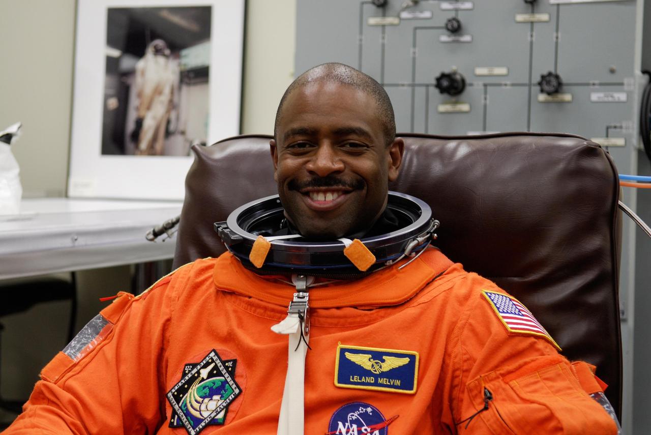 KENNEDY SPACE CENTER, FLA. --  Space shuttle Atlantis STS-122 Mission Specialist Leland Melvin tries on his launch and entry suit, preparing for launch. The fitting is part of terminal countdown demonstration test, or TCDT, activities the crew is undertaking at NASA's Kennedy Space Center.  The TCDT provides astronauts and ground crews with equipment familiarization, emergency egress training and a simulated launch countdown. On mission STS-122, Atlantis will deliver the Columbus module to the International Space Station. The European Space Agency's largest single contribution to the station, Columbus is a multifunctional, pressurized laboratory that will be permanently attached to U.S. Node 2, called Harmony. The laboratory will expand the research facilities aboard the station, providing crew members and scientists from around the world the ability to conduct a variety of experiments in the physical, materials and life sciences. Launch is targeted for Dec. 6.  Photo credit: NASA/Kim Shiflett