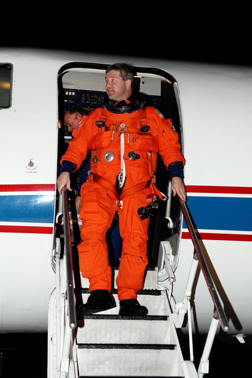 KENNEDY SPACE CENTER, FLA. -- Space shuttle Atlantis STS-122 Commander Steve Frick disembarks from a shuttle training aircraft, or STA, at Kennedy Space Center's Shuttle Landing Facility. He and STS-122 Pilot Alan Poindexter have just completed a practice session landing the STA. The STA is a Grumman American Aviation-built Gulf Stream II jet that was modified to simulate an orbiter's cockpit, motion and visual cues, and handling qualities. In flight, the STA duplicates the orbiter's atmospheric descent trajectory from approximately 35,000 feet altitude to landing on a runway. Because the orbiter is unpowered during re-entry and landing, its high-speed glide must be perfectly executed the first time. The training is part of terminal countdown demonstration test, or TCDT, activities. The TCDT provides astronauts and ground crews with equipment familiarization, emergency egress training and a simulated launch countdown. On mission STS-122, Atlantis will deliver the European Space Agency's Columbus module to the International Space Station. Columbus is a multifunctional, pressurized laboratory that will be permanently attached to U.S. Node 2, called Harmony, and will expand the research facilities aboard the station. Launch is targeted for Dec. 6. Photo credit: NASA/Kim Shiflett
