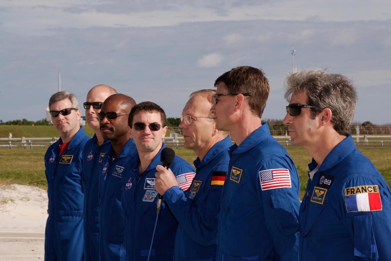 KENNEDY SPACE CENTER, FLA. --  At the slidewire basket landing on Launch Pad 39A, the space shuttle Atlantis STS-122 crew responds to questions from the media.  From left are Commander Steve Frick; Pilot Alan Poindexter; and Mission Specialists Leland Melvin, Rex Walheim, Hans Schlegel (with the microphone), Stanley Love and Leopold Eyharts.  Schlegel and Eyharts are with the European Space Agency.  Eyharts will remain on the International Space Station as a flight engineer for Expedition 16 following the STS-122 mission.  The STS-122 crew is at NASA's Kennedy Space Center to take part in terminal countdown demonstration test, or TCDT, activities, a standard part of launch preparations. The TCDT provides astronauts and ground crews with equipment familiarization, emergency egress training and a simulated launch countdown. On mission STS-122, Atlantis will deliver the European Space Agency's Columbus module to the International Space Station.  Columbus is a multifunctional, pressurized laboratory that will be permanently attached to U.S. Node 2, called Harmony, and will expand the research facilities aboard the station. Launch is targeted for Dec. 6.  Photo credit: NASA/Kim Shiflett