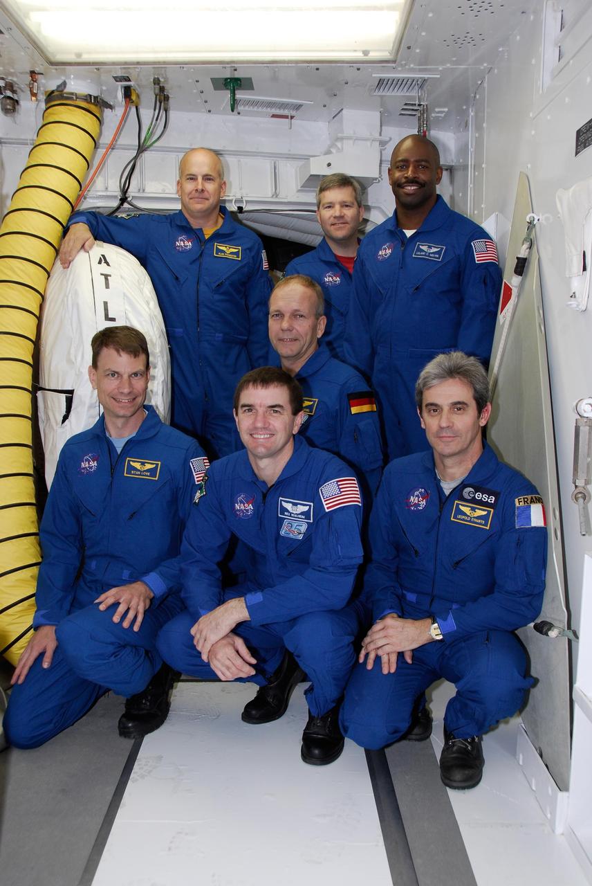KENNEDY SPACE CENTER, FLA. -- Gathered in the white room on Launch Pad 39A, the space shuttle Atlantis STS-122 crew pauses for a photo. Standing, from left, are Pilot Alan Poindexter, Commander Steve Frick and Mission Specialist Leland Melvin. Kneeling, center, is Mission Specialist Hans Schlegel. In the bottom row, from left, are Stanley Love, Rex Walheim and Leopold Eyharts. Schlegel and Eyharts are with the European Space Agency. Eyharts will remain on the International Space Station as a flight engineer for Expedition 16 following the STS-122 mission. The STS-122 crew is at NASA's Kennedy Space Center to take part in terminal countdown demonstration test, or TCDT, activities, a standard part of launch preparations. The TCDT provides astronauts and ground crews with equipment familiarization and a simulated launch countdown before launch. On mission STS-122, Atlantis will deliver the European Space Agency's Columbus module to the International Space Station. Columbus is a multifunctional, pressurized laboratory that will be permanently attached to U.S. Node 2, called Harmony, and will expand the research facilities aboard the station. Launch is targeted for Dec. 6. Photo credit: NASA/Kim Shiflett