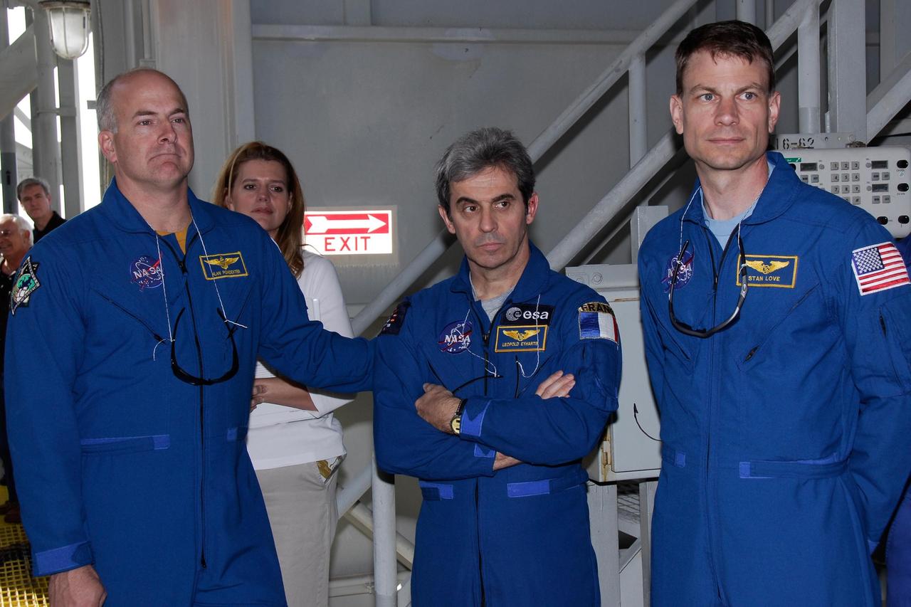 KENNEDY SPACE CENTER, FLA. -- The space shuttle Atlantis STS-122 crew receives instruction on emergency exit from the fixed service structure on Launch Pad 39A. From left are Pilot Alan Poindexter and Mission Specialists Leopold Eyharts and Stanley Love. Eyharts is with the European Space Agency and will remain on the International Space Station as a flight engineer for Expedition 16 following the STS-122 mission. The STS-122 crew is at NASA's Kennedy Space Center to take part in terminal countdown demonstration test, or TCDT, activities, a standard part of launch preparations. The TCDT provides astronauts and ground crews with equipment familiarization and a simulated launch countdown before launch. On mission STS-122, Atlantis will deliver the European Space Agency's Columbus module to the International Space Station. Columbus is a multifunctional, pressurized laboratory that will be permanently attached to U.S. Node 2, called Harmony, and will expand the research facilities aboard the station. Launch is targeted for Dec. 6. Photo credit: NASA/Kim Shiflett