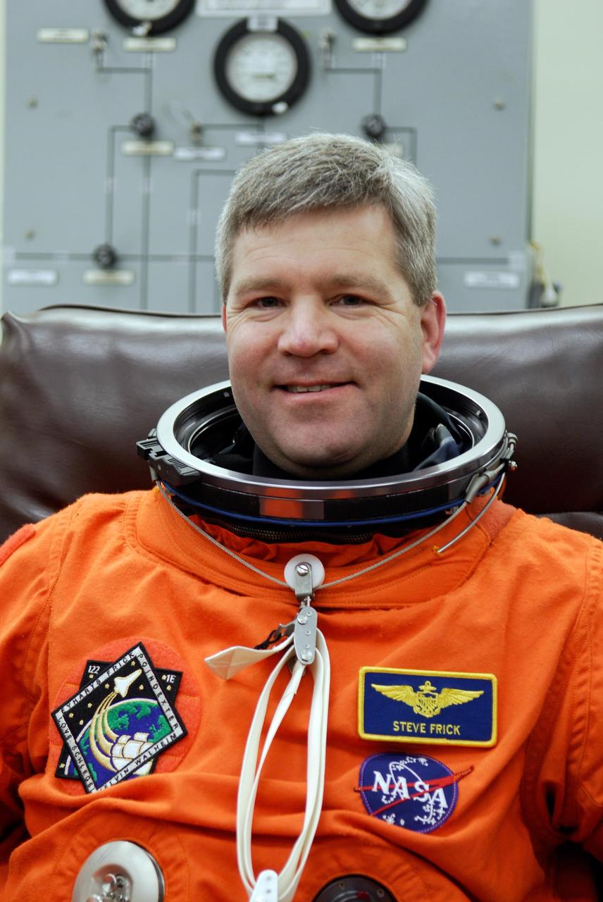 KENNEDY SPACE CENTER, FLA. -- Space shuttle Atlantis STS-122 Commander Steve Frick dons his launch and entry suit, in astronaut crew quarters. The STS-122 crew is preparing for a simulated launch countdown aboard Atlantis, part of terminal countdown demonstration test, or TCDT, activities at NASA's Kennedy Space Center. The TCDT is a dress rehearsal for launch and also provides astronauts and ground crews with equipment familiarization and emergency egress training. On mission STS-122, Atlantis will deliver the Columbus module to the International Space Station. The European Space Agency's largest single contribution to the station, Columbus is a multifunctional, pressurized laboratory that will be permanently attached to U.S. Node 2, called Harmony. The laboratory will expand the research facilities aboard the station, providing crew members and scientists from around the world the ability to conduct a variety of experiments in the physical, materials and life sciences. Launch is targeted for Dec. 6. Photo credit: NASA/Kim Shiflett