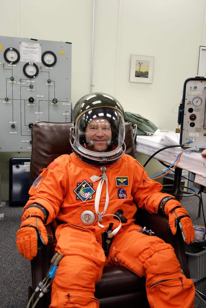 KENNEDY SPACE CENTER, FLA. -- Space shuttle Atlantis STS-122 Commander Steve Frick is fully attired in his launch and entry suit, in astronaut crew quarters. The STS-122 crew is preparing for a simulated launch countdown aboard Atlantis, part of terminal countdown demonstration test, or TCDT, activities at NASA's Kennedy Space Center. The TCDT is a dress rehearsal for launch and also provides astronauts and ground crews with equipment familiarization and emergency egress training. On mission STS-122, Atlantis will deliver the Columbus module to the International Space Station. The European Space Agency's largest single contribution to the station, Columbus is a multifunctional, pressurized laboratory that will be permanently attached to U.S. Node 2, called Harmony. The laboratory will expand the research facilities aboard the station, providing crew members and scientists from around the world the ability to conduct a variety of experiments in the physical, materials and life sciences. Launch is targeted for Dec. 6. Photo credit: NASA/Kim Shiflett