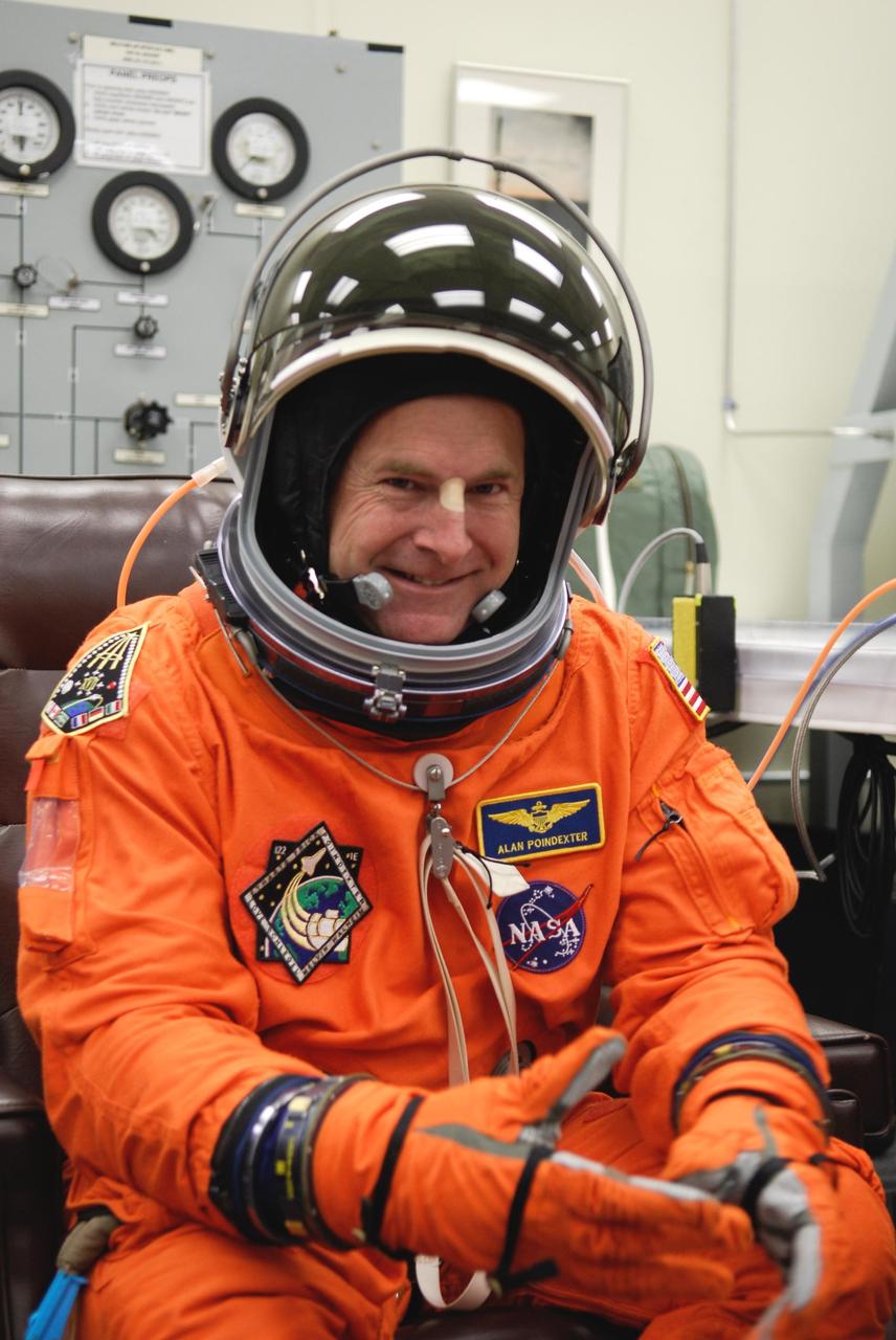 KENNEDY SPACE CENTER, FLA. -- Space shuttle Atlantis STS-122 Pilot Alan Poindexter awaits the final adjustments to his launch and entry suit, in astronaut crew quarters. The STS-122 crew is preparing for a simulated launch countdown aboard Atlantis, part of terminal countdown demonstration test, or TCDT, activities at NASA's Kennedy Space Center. The TCDT is a dress rehearsal for launch and also provides astronauts and ground crews with equipment familiarization and emergency egress training. On mission STS-122, Atlantis will deliver the Columbus module to the International Space Station. The European Space Agency's largest single contribution to the station, Columbus is a multifunctional, pressurized laboratory that will be permanently attached to U.S. Node 2, called Harmony. The laboratory will expand the research facilities aboard the station, providing crew members and scientists from around the world the ability to conduct a variety of experiments in the physical, materials and life sciences. Launch is targeted for Dec. 6. Photo credit: NASA/Kim Shiflett