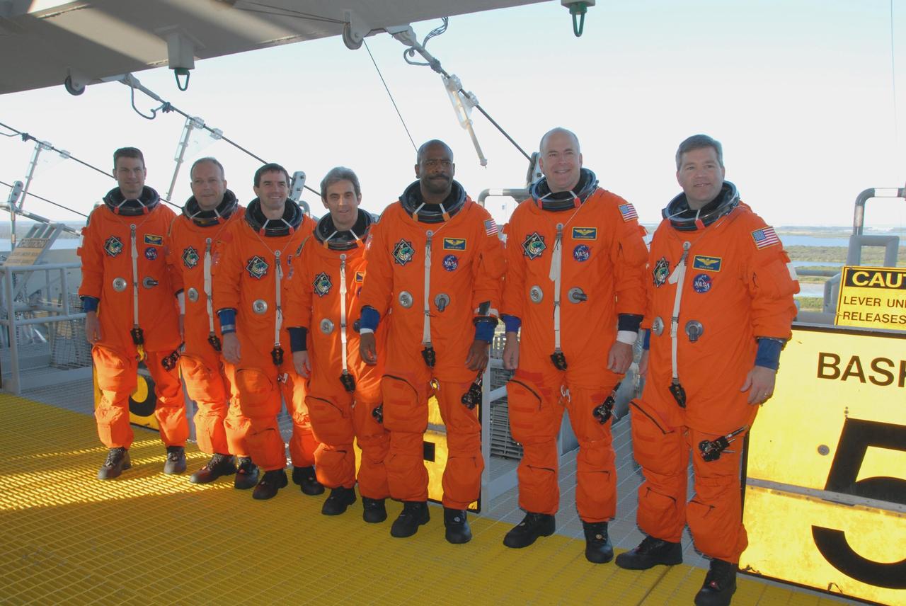 KENNEDY SPACE CENTER, FLA. --  The space shuttle Atlantis STS-122 crew arrives at Launch Pad 39A, dressed in launch and entry suits, to participate in a simulated launch countdown aboard Atlantis.  From left are Mission Specialists Stanley Love, Hans Schlegel, Rex Walheim, Leopold Eyharts and Leland Melvin; Pilot Alan Poindexter; and Commander Steve Frick.  Schlegel and Eyharts are with the European Space Agency.  Eyharts will remain on the International Space Station as a flight engineer for Expedition 16 following the STS-122 mission.   The exercise is part of terminal countdown demonstration test, or TCDT, activities at NASA's Kennedy Space Center. The TCDT is a dress rehearsal for launch and also provides astronauts and ground crews with equipment familiarization and emergency egress training.  On mission STS-122, Atlantis will deliver the Columbus module to the International Space Station. The European Space Agency's largest single contribution to the station, Columbus is a multifunctional, pressurized laboratory that will be permanently attached to U.S. Node 2, called Harmony. The laboratory will expand the research facilities aboard the station, providing crew members and scientists from around the world the ability to conduct a variety of experiments in the physical, materials and life sciences. Atlantis' launch is targeted for Dec. 6.  Photo credit: NASA/George Shelton