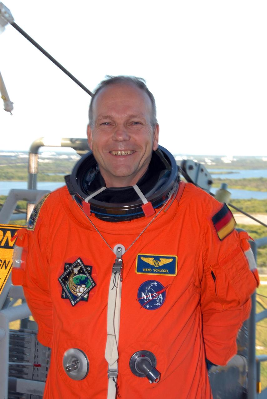 KENNEDY SPACE CENTER, FLA. --  Space shuttle Atlantis STS-122 Mission Specialist Hans Schlegel arrives at Launch Pad 39A, dressed in his launch and entry suit, to participate in a simulated launch countdown aboard Atlantis.  Schlegel is with the European Space Agency.   The exercise is part of terminal countdown demonstration test, or TCDT, activities at NASA's Kennedy Space Center. The TCDT is a dress rehearsal for launch and also provides astronauts and ground crews with equipment familiarization and emergency egress training.  On mission STS-122, Atlantis will deliver the Columbus module to the International Space Station. The European Space Agency's largest single contribution to the station, Columbus is a multifunctional, pressurized laboratory that will be permanently attached to U.S. Node 2, called Harmony. The laboratory will expand the research facilities aboard the station, providing crew members and scientists from around the world the ability to conduct a variety of experiments in the physical, materials and life sciences. Atlantis' launch is targeted for Dec. 6.  Photo credit: NASA/George Shelton
