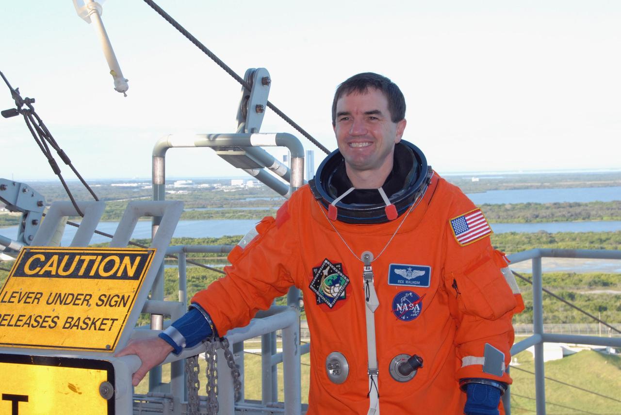 KENNEDY SPACE CENTER, FLA. --  Space shuttle Atlantis STS-122 Mission Specialist Rex Walheim arrives at Launch Pad 39A, dressed in his launch and entry suit, to participate in a simulated launch countdown aboard Atlantis.   The exercise is part of terminal countdown demonstration test, or TCDT, activities at NASA's Kennedy Space Center. The TCDT is a dress rehearsal for launch and also provides astronauts and ground crews with equipment familiarization and emergency egress training.  On mission STS-122, Atlantis will deliver the Columbus module to the International Space Station. The European Space Agency's largest single contribution to the station, Columbus is a multifunctional, pressurized laboratory that will be permanently attached to U.S. Node 2, called Harmony. The laboratory will expand the research facilities aboard the station, providing crew members and scientists from around the world the ability to conduct a variety of experiments in the physical, materials and life sciences. Atlantis' launch is targeted for Dec. 6.  Photo credit: NASA/George Shelton