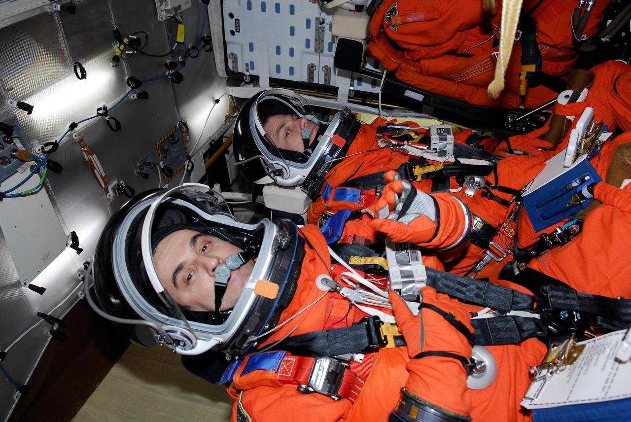 KENNEDY SPACE CENTER, FLA. --  Space shuttle Atlantis STS-122 Mission Specialists Leopold Eyharts, left, and Stanley Love are strapped into their seats on Atlantis' fight deck during a simulated launch countdown.  Eyharts is with the European Space Agency and will remain on the International Space Station as a flight engineer for Expedition 16 following the STS-122 mission.   The exercise is part of terminal countdown demonstration test, or TCDT, activities at NASA's Kennedy Space Center. The TCDT is a dress rehearsal for launch and also provides astronauts and ground crews with equipment familiarization and emergency egress training.  On mission STS-122, Atlantis will deliver the Columbus module to the International Space Station. The European Space Agency's largest single contribution to the station, Columbus is a multifunctional, pressurized laboratory that will be permanently attached to U.S. Node 2, called Harmony. The laboratory will expand the research facilities aboard the station, providing crew members and scientists from around the world the ability to conduct a variety of experiments in the physical, materials and life sciences. Atlantis' launch is targeted for Dec. 6.  Photo credit: NASA/Kim Shiflett