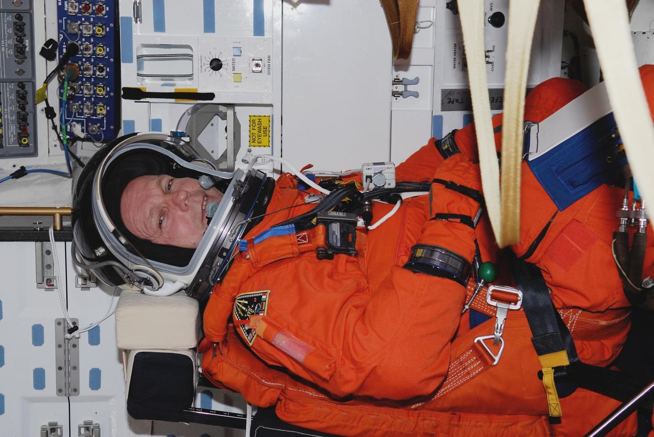 KENNEDY SPACE CENTER, FLA. --  Space shuttle Atlantis STS-122 Mission Specialist Hans Schlegel is strapped into his seat on Atlantis' fight deck during a simulated launch countdown.  Schlegel is with the European Space Agency.   The exercise is part of terminal countdown demonstration test, or TCDT, activities at NASA's Kennedy Space Center. The TCDT is a dress rehearsal for launch and also provides astronauts and ground crews with equipment familiarization and emergency egress training.  On mission STS-122, Atlantis will deliver the Columbus module to the International Space Station. The European Space Agency's largest single contribution to the station, Columbus is a multifunctional, pressurized laboratory that will be permanently attached to U.S. Node 2, called Harmony. The laboratory will expand the research facilities aboard the station, providing crew members and scientists from around the world the ability to conduct a variety of experiments in the physical, materials and life sciences. Atlantis' launch is targeted for Dec. 6.  Photo credit: NASA/Kim Shiflett