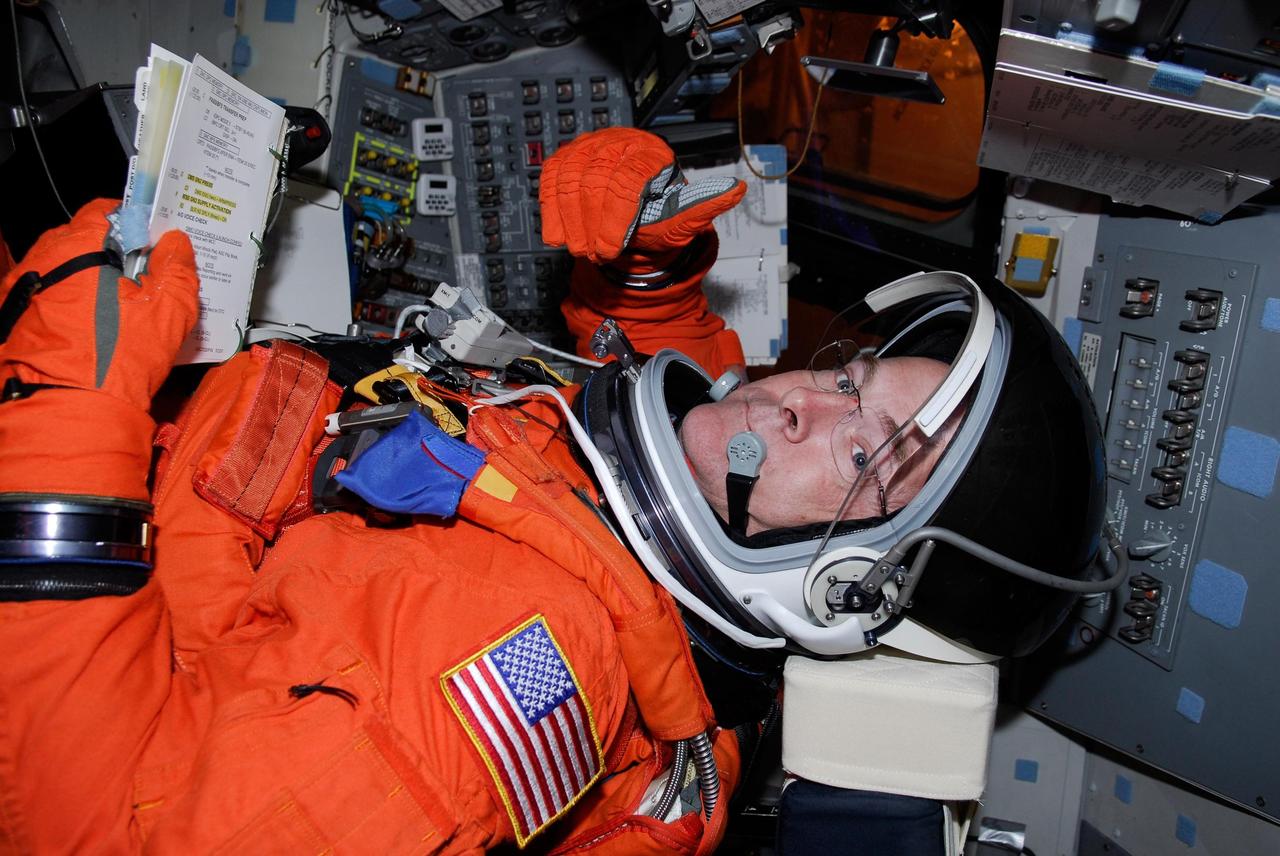 KENNEDY SPACE CENTER, FLA. --  Space shuttle Atlantis STS-122 Pilot Alan Poindexter, strapped in his seat in Atlantis' cockpit, signals that he is ready to proceed with the simulated launch countdown.   The exercise is part of terminal countdown demonstration test, or TCDT, activities at NASA's Kennedy Space Center. The TCDT is a dress rehearsal for launch and also provides astronauts and ground crews with equipment familiarization and emergency egress training.  On mission STS-122, Atlantis will deliver the Columbus module to the International Space Station. The European Space Agency's largest single contribution to the station, Columbus is a multifunctional, pressurized laboratory that will be permanently attached to U.S. Node 2, called Harmony. The laboratory will expand the research facilities aboard the station, providing crew members and scientists from around the world the ability to conduct a variety of experiments in the physical, materials and life sciences. Atlantis' launch is targeted for Dec. 6.  Photo credit: NASA/Kim Shiflett