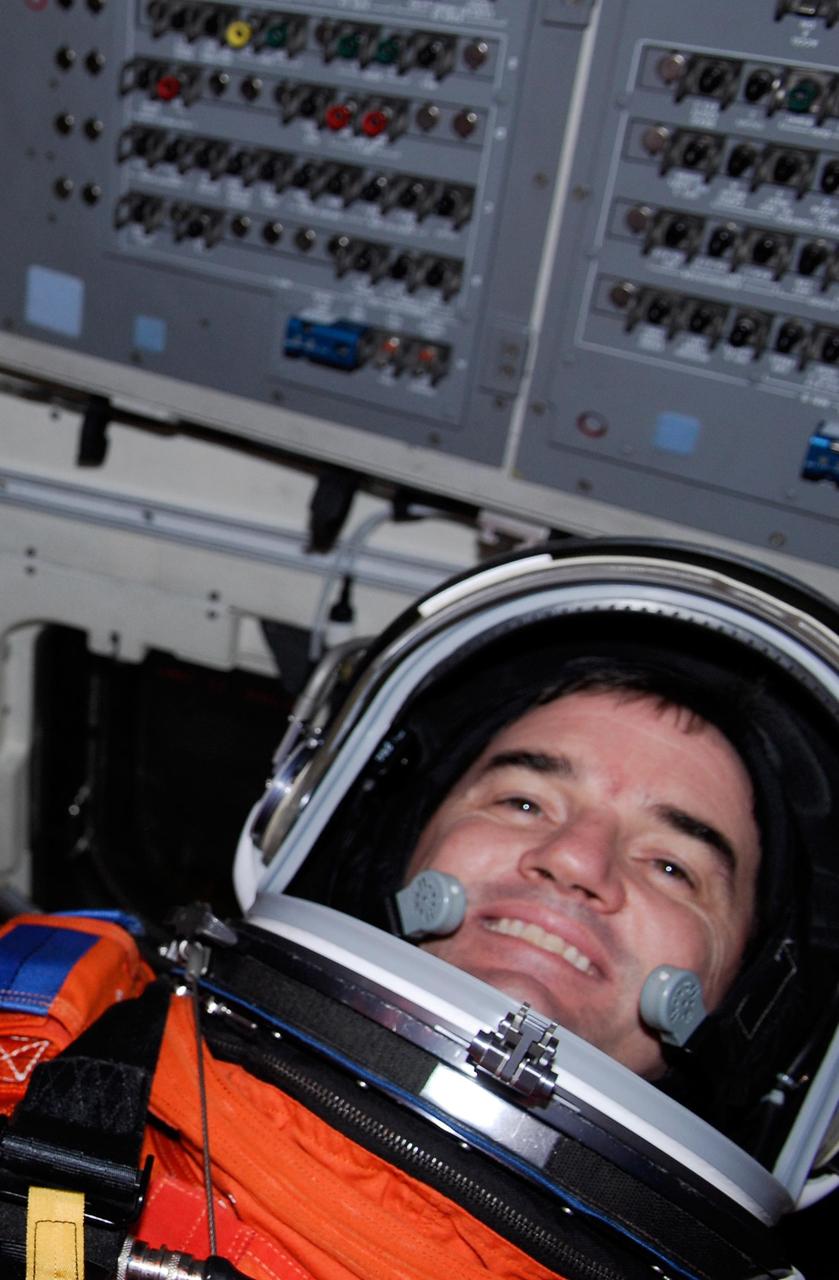 KENNEDY SPACE CENTER, FLA. --  Space shuttle Atlantis STS-122 Mission Specialist Rex Walheim is strapped into his seat on Atlantis' fight deck during a simulated launch countdown.   The exercise is part of terminal countdown demonstration test, or TCDT, activities at NASA's Kennedy Space Center. The TCDT is a dress rehearsal for launch and also provides astronauts and ground crews with equipment familiarization and emergency egress training.  On mission STS-122, Atlantis will deliver the Columbus module to the International Space Station. The European Space Agency's largest single contribution to the station, Columbus is a multifunctional, pressurized laboratory that will be permanently attached to U.S. Node 2, called Harmony. The laboratory will expand the research facilities aboard the station, providing crew members and scientists from around the world the ability to conduct a variety of experiments in the physical, materials and life sciences. Atlantis' launch is targeted for Dec. 6.  Photo credit: NASA/Kim Shiflett