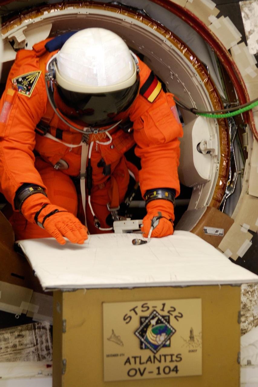 KENNEDY SPACE CENTER, FLA. --  Space shuttle Atlantis STS-122 Mission Specialist Hans Schlegel exits Atlantis' fight deck following a simulated launch countdown at Launch Pad 39A.  Schlegel is with the European Space Agency.  The exercise is part of terminal countdown demonstration test, or TCDT, activities at NASA's Kennedy Space Center. The TCDT is a dress rehearsal for launch and also provides astronauts and ground crews with equipment familiarization and emergency egress training.  On mission STS-122, Atlantis will deliver the Columbus module to the International Space Station. The European Space Agency's largest single contribution to the station, Columbus is a multifunctional, pressurized laboratory that will be permanently attached to U.S. Node 2, called Harmony. The laboratory will expand the research facilities aboard the station, providing crew members and scientists from around the world the ability to conduct a variety of experiments in the physical, materials and life sciences. Atlantis' launch is targeted for Dec. 6.  Photo credit: NASA/Kim Shiflett
