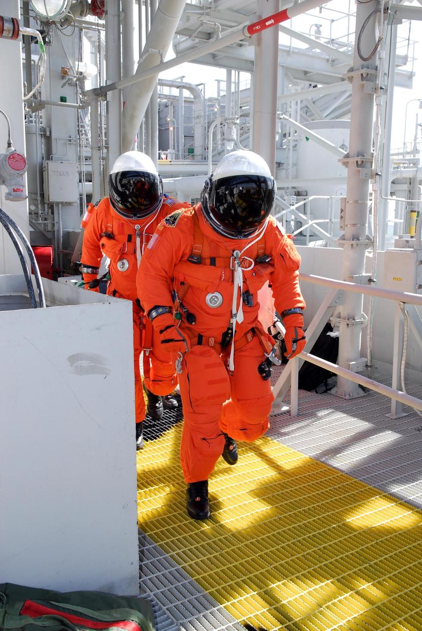 KENNEDY SPACE CENTER, FLA. --  Members of space shuttle Atlantis' STS-122 crew exit Atlantis' fight deck following a simulated launch countdown at Launch Pad 39A.   The exercise is part of terminal countdown demonstration test, or TCDT, activities at NASA's Kennedy Space Center. The TCDT is a dress rehearsal for launch and also provides astronauts and ground crews with equipment familiarization and emergency egress training.  On mission STS-122, Atlantis will deliver the Columbus module to the International Space Station. The European Space Agency's largest single contribution to the station, Columbus is a multifunctional, pressurized laboratory that will be permanently attached to U.S. Node 2, called Harmony. The laboratory will expand the research facilities aboard the station, providing crew members and scientists from around the world the ability to conduct a variety of experiments in the physical, materials and life sciences. Atlantis' launch is targeted for Dec. 6.  Photo credit: NASA/Kim Shiflett