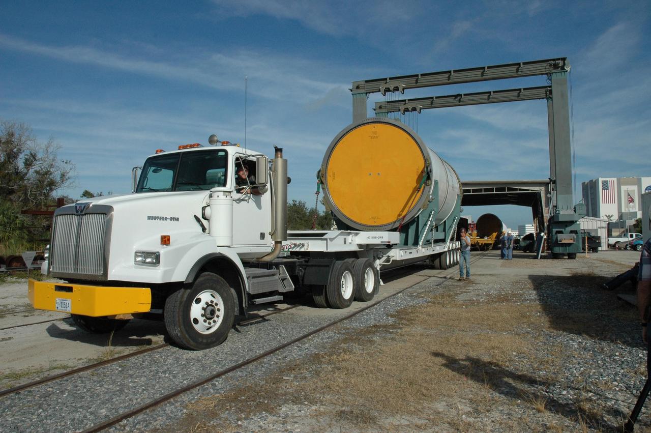 KENNEDY SPACE CENTER, FLA. --  Another solid rocket booster segment arrives at the railhead at the railroad yard at NASA's Kennedy Space Center.  The spent segment will be placed on a railroad car and covered for the long trip back to Utah.   After a mission, the spent boosters are recovered, cleaned, disassembled, refurbished and reused after each launch. After hydrolasing the interior of each segment, they are placed on flatbed trucks.  The individual booster segments are transferred to a railhead located at the railroad yard at NASA's Kennedy Space Center. The long train of segments is part of the twin solid rocket boosters used to launch space shuttle Discovery in October.  The NASA Railroad locomotive backs up the rail cars and the segment is lowered onto the car. The covered segments are moved to Titusville for interchange with Florida East Coast Railway to begin the trip back to Utah.  Photo credit: NASA/Amanda Diller