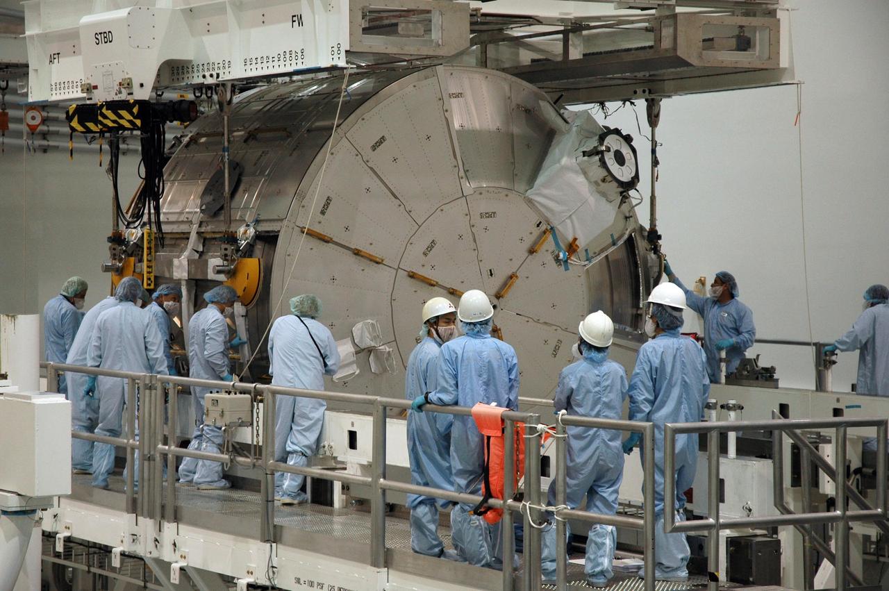 KENNEDY SPACE CENTER, FLA. -- In the Space Station Processing Facility at NASA's Kennedy Space Center, workers stand by as the Experiment Logistics Module Pressurized Section, or ELM-PS, is lowered onto the rotation stand. Part of the Japanese Experiment Module, called Kibo, the ELM-PS is the primary payload for space shuttle Endeavour's STS-123 mission, which is targeted for launch to the International Space Station on Feb. 14. Photo credit: NASA/Dimitri Gerondidakis