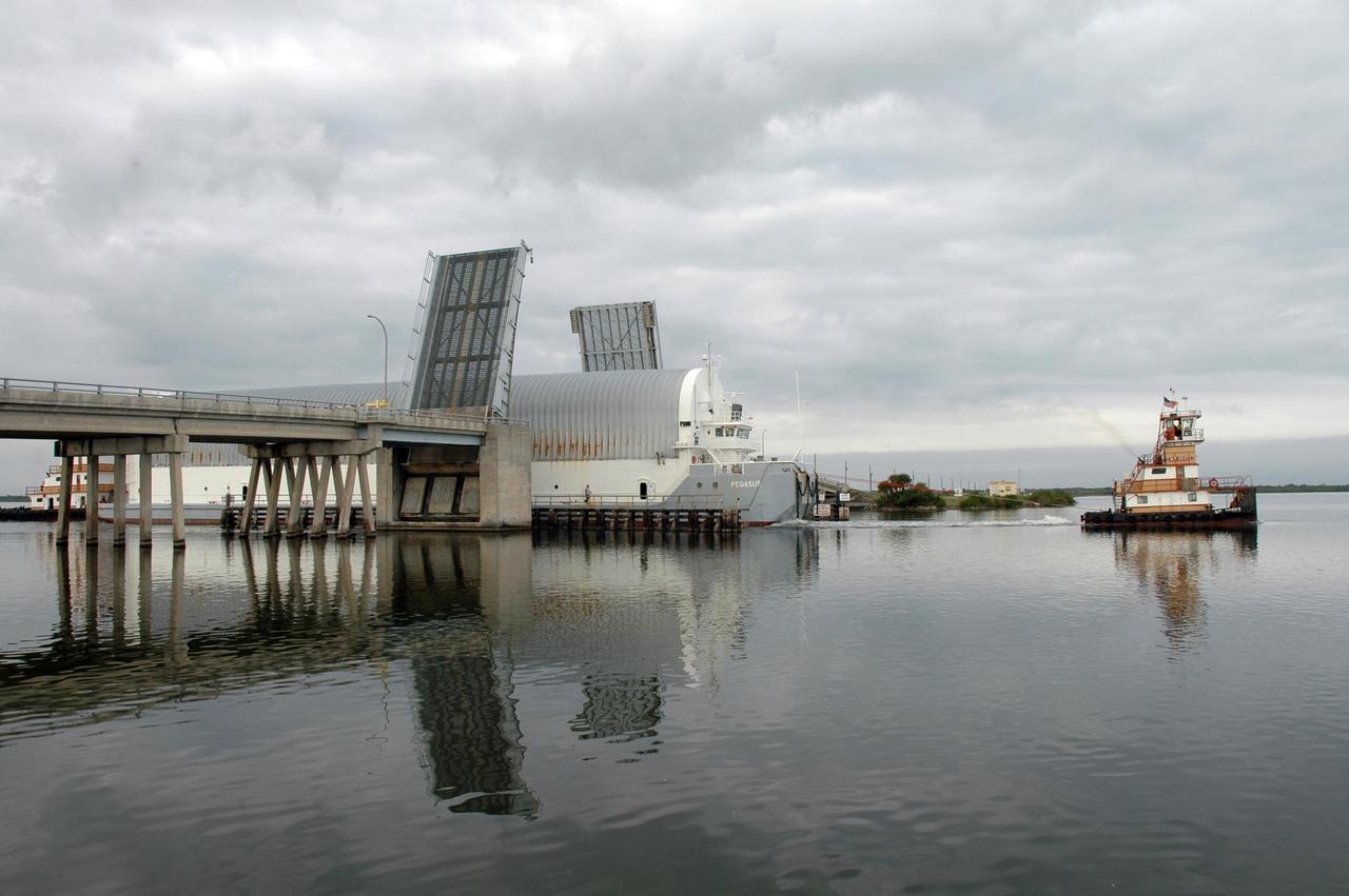 KENNEDY SPACE CENTER, FLA. -- Towed by a tugboat, the Pegasus barge passes through the open bridge in the Banana River on its way to the turn basin in the Launch Complex 39 Area at NASA's Kennedy Space Center. The barge is carrying the external tank for space shuttle Endeavour's STS-123 mission. After offloading, the tank will be transported to the Vehicle Assembly Building. Endeavour is targeted for launch to the International Space Station on Feb. 14. Photo credit: NASA/Jim Grossmann