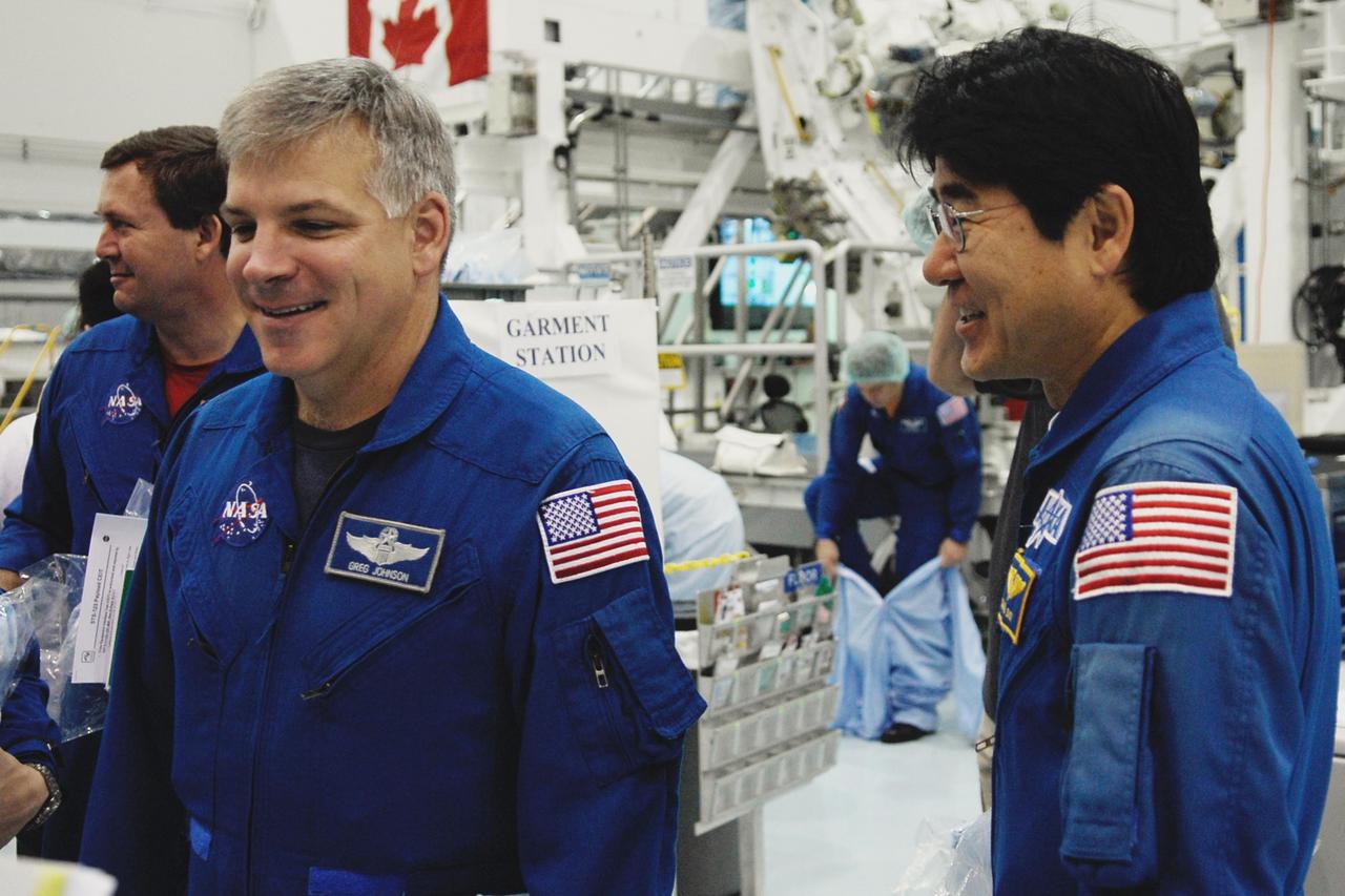 KENNEDY SPACE CENTER, FLA. -- In the Space Station Processing Facility at NASA's Kennedy Space Center, members of space shuttle Endeavour's STS-123 crew get ready to inspect part of the payload for the mission, the Special Purpose Dexterous Manipulator, known as Dextre.  Seen in front are Pilot Gregory Johnson and Mission Specialist Takao Doi, who represents the Japanese Aerospace and Exploration Agency.   Dextre will work with the mobile base and Canadarm2 on the International Space Station to perform critical construction and maintenance tasks.  The crew is at Kennedy for crew equipment interface test, a process of familiarization with payloads, hardware and the space shuttle.  The STS-123 mission is targeted for launch on Feb. 14. It will be the 25th assembly flight of the station.  Photo credit: NASA/Kim Shiflett