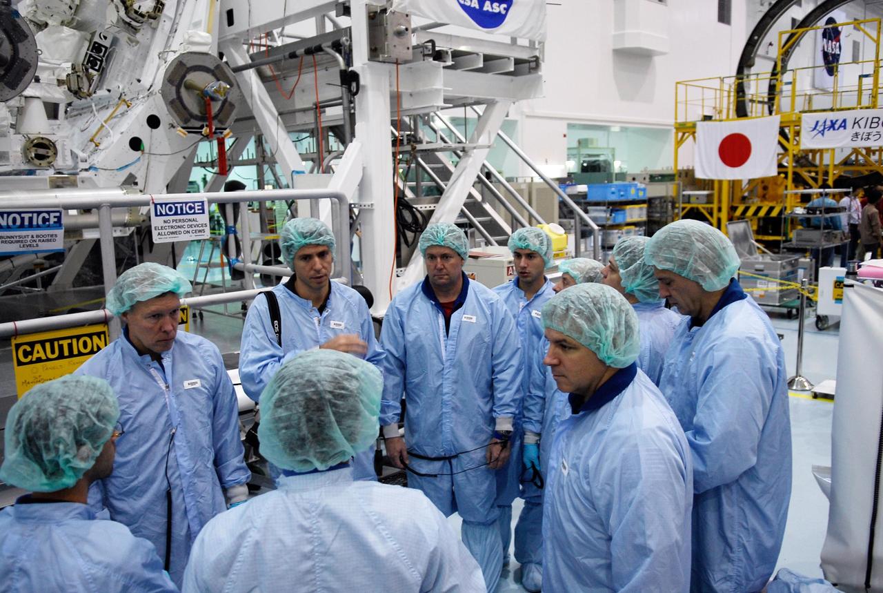 KENNEDY SPACE CENTER, FLA. --  In the Space Station Processing Facility at NASA's Kennedy Space Center, members of space shuttle Endeavour's STS-123 crew, dressed in protective suits, get ready to inspect part of the payload for the mission, the Special Purpose Dexterous Manipulator, known as Dextre.  At left is Commander Dominic Gorie and at center is Mission Specialist Michael Foreman.  At right are Pilot Gregory Johnson and  Mission Specialist Richard Linnehan.  Dextre will work with the mobile base and Canadarm2 on the International Space Station to perform critical construction and maintenance tasks.  The crew is at Kennedy for crew equipment interface test, a process of familiarization with payloads, hardware and the space shuttle.  The STS-123 mission is targeted for launch on Feb. 14. It will be the 25th assembly flight of the station.  Photo credit: NASA/Kim Shiflett