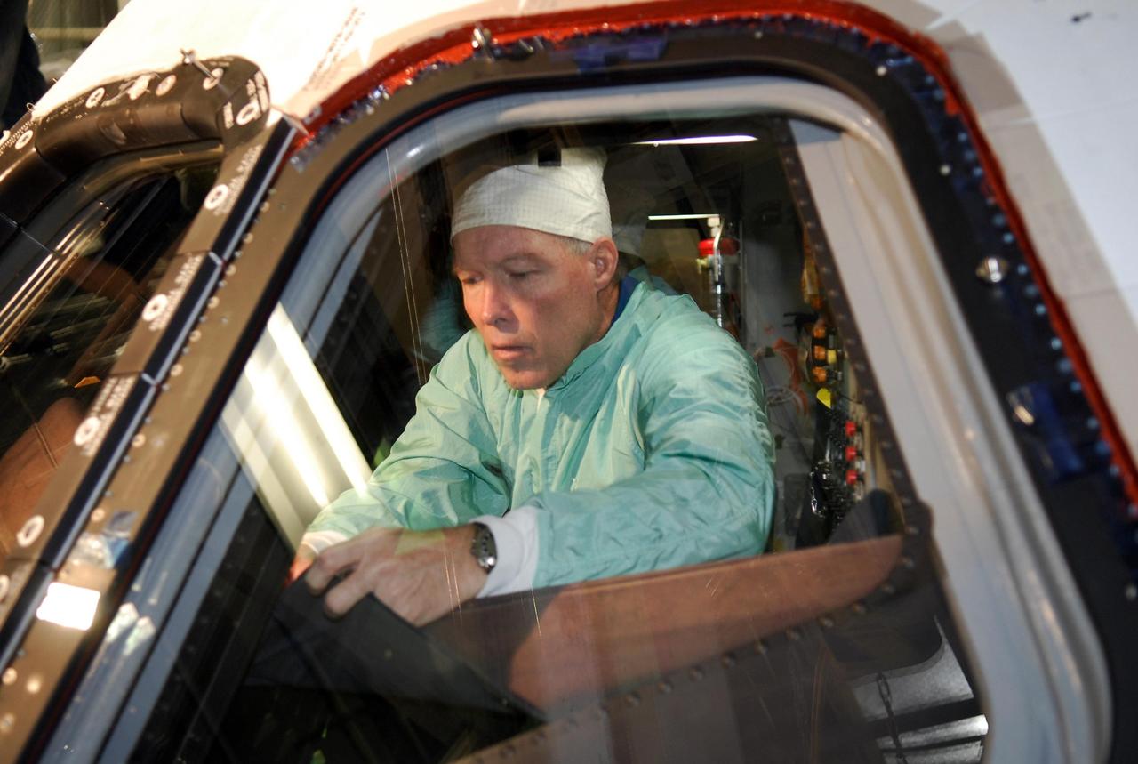KENNEDY SPACE CENTER, FLA. --  In the Orbiter Processing Facility at NASA's Kennedy Space Center, space shuttle Endeavour's STS-123 Commander Dominic Gorie inspects the window in space shuttle Endeavour.  The crew is at Kennedy for crew equipment interface test, a process of familiarization with payloads, hardware and the space shuttle.  The STS-123 mission is targeted for launch on Feb. 14. It will be the 25th assembly flight of the station.  Photo credit: NASA/Kim Shiflett