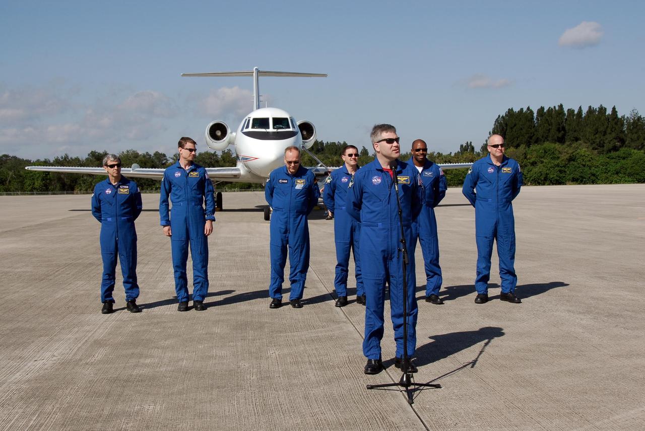 KENNEDY SPACE CENTER, FLA. -- After arrival at NASA's Kennedy Space Center, the STS-122 mission crew greet the media on the Shuttle Landing Facility. At the microphone is Commander Steve Frick. Behind him, left to right, are Mission Specialists Leopold Eyharts, Stanley Love, Hans Schlegel, Rex Walheim and Leland Melvin, and Pilot Alan Poindexter. Eyhars and Schlegel represent the European Space Agency. The crew's arrival signals the imminent launch of space shuttle Atlantis on mission STS-122. The launch countdown begins at 7 p.m. Dec. 3. Launch is scheduled for 4:31 p.m. EST on Dec. 6. Atlantis will carry the Columbus Lab, Europe’s largest contribution to the construction of the International Space Station. It will support scientific and technological research in a microgravity environment. Columbus, a program of ESA, is a multifunctional, pressurized laboratory that will be permanently attached to Node 2 of the space station to carry out experiments in materials science, fluid physics and biosciences, as well as to perform a number of technological applications. Photo credit: NASA/Kim Shiflett