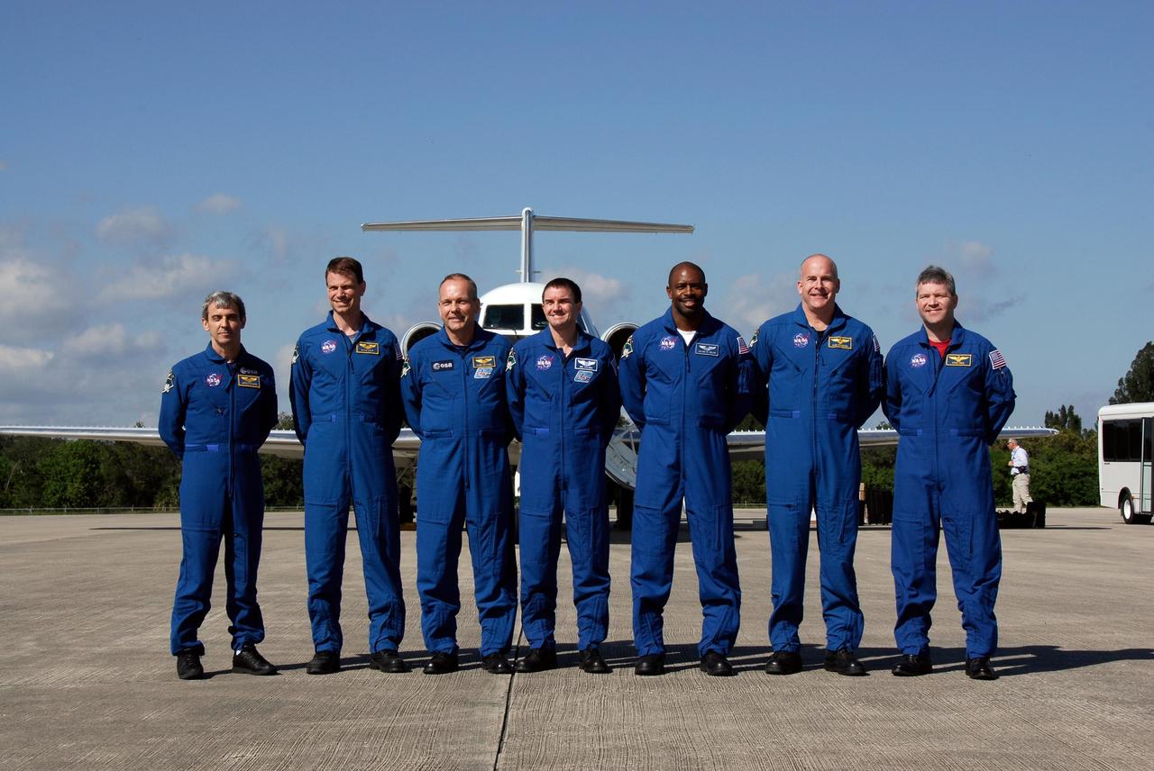 KENNEDY SPACE CENTER, FLA. --  The STS-122 crew pose on the Shuttle Landing Facility at NASA's Kennedy Space Center after their arrival for launch.  From left are Mission Specialists Leopold Eyharts, Stanley Love, Hans Schlegel, Rex Walheim and Leland Melvin, and Pilot Alan Poindexter and Commander Steve Frick. Eyharts and Schlegel represent the European Space Agency.  Eyharts will remain on the International Space Station while Atlantis returns flight engineer Daniel Tani.  The crew's arrival signals the imminent launch of space shuttle Atlantis on mission STS-122.  The launch countdown begins at 7 p.m. Dec. 3.  Launch is scheduled for 4:31 p.m. EST on Dec. 6.  Atlantis will carry the Columbus Lab, Europe's largest contribution to the construction of the International Space Station. It will support scientific and technological research in a microgravity environment. Columbus, a program of ESA, is a multifunctional, pressurized laboratory that will be permanently attached to Node 2 of the space station to carry out experiments in materials science, fluid physics and biosciences, as well as to perform a number of technological applications.  Photo credit: NASA/Kim Shiflett