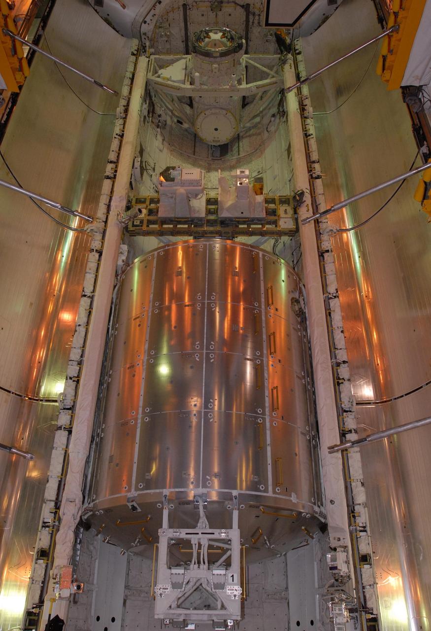 KENNEDY SPACE CENTER, FLA. -- On Launch Pad 39A, space shuttle Atlantis' payload bay doors are closing. Seen here are the Columbus Laboratory (below), the integrated cargo carrier - lite (middle) and the orbital docking system (above). Atlantis is being secured for launch on Dec. 6 on mission STS-122 to the International Space Station. The Columbus laboratory module, built by the European Space Agency, is approximately 23 feet long and 15 feet wide, allowing it to hold 10 large racks of experiments. The carrier holds three elements: a nitrogen tank assembly that is part of the external active thermal control system on the International Space Station, the European Technology Exposure Facility composed of nine science instruments and an autonomous temperature measurement unit, and the SOLAR payload designed for sun observation. Photo credit: NASA/George Shelton