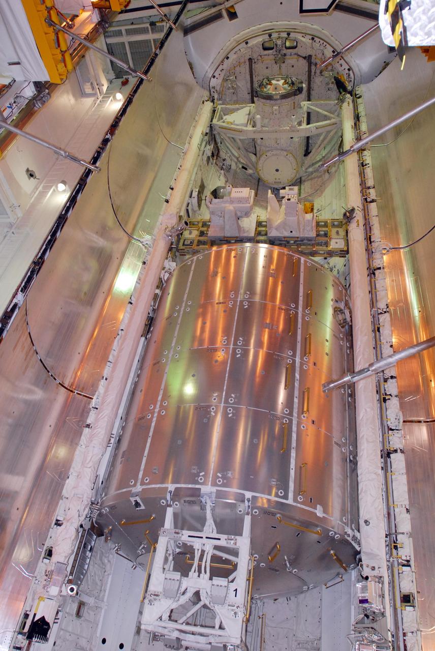 KENNEDY SPACE CENTER, FLA. -- On Launch Pad 39A, space shuttle Atlantis' payload bay doors are closing. Seen here are the Columbus Laboratory (below), the integrated cargo carrier - lite (middle) and the orbital docking system (above). Atlantis is being secured for launch on Dec. 6 on mission STS-122 to the International Space Station. The Columbus laboratory module, built by the European Space Agency, is approximately 23 feet long and 15 feet wide, allowing it to hold 10 large racks of experiments. The carrier holds three elements: a nitrogen tank assembly that is part of the external active thermal control system on the International Space Station, the European Technology Exposure Facility composed of nine science instruments and an autonomous temperature measurement unit, and the SOLAR payload designed for sun observation. Photo credit: NASA/George Shelton